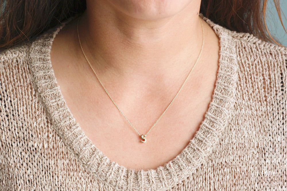 Short gold necklace with on sale charm