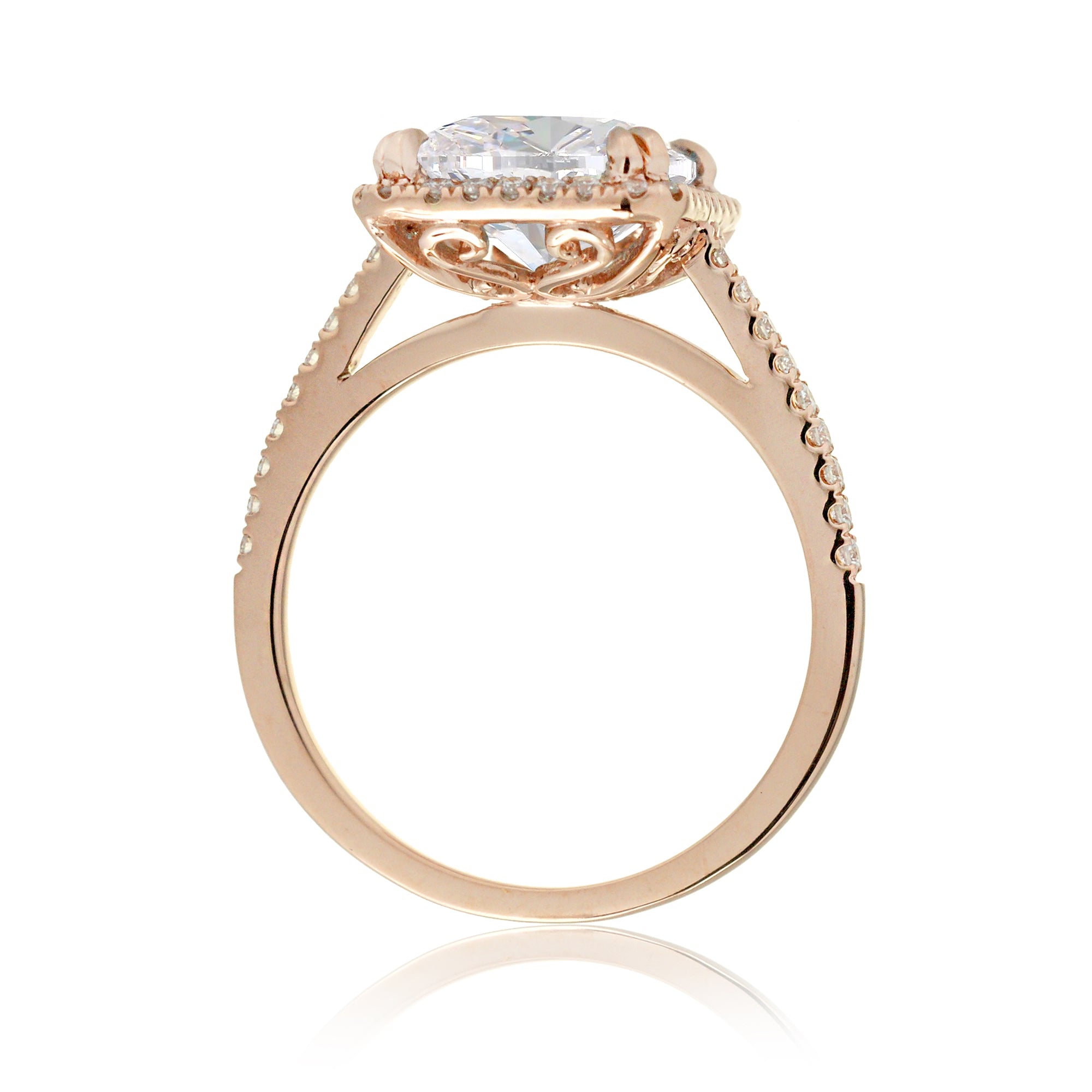 Cushion cut moissanite engagement ring with a diamond halo on the Signature elongated rose gold setting