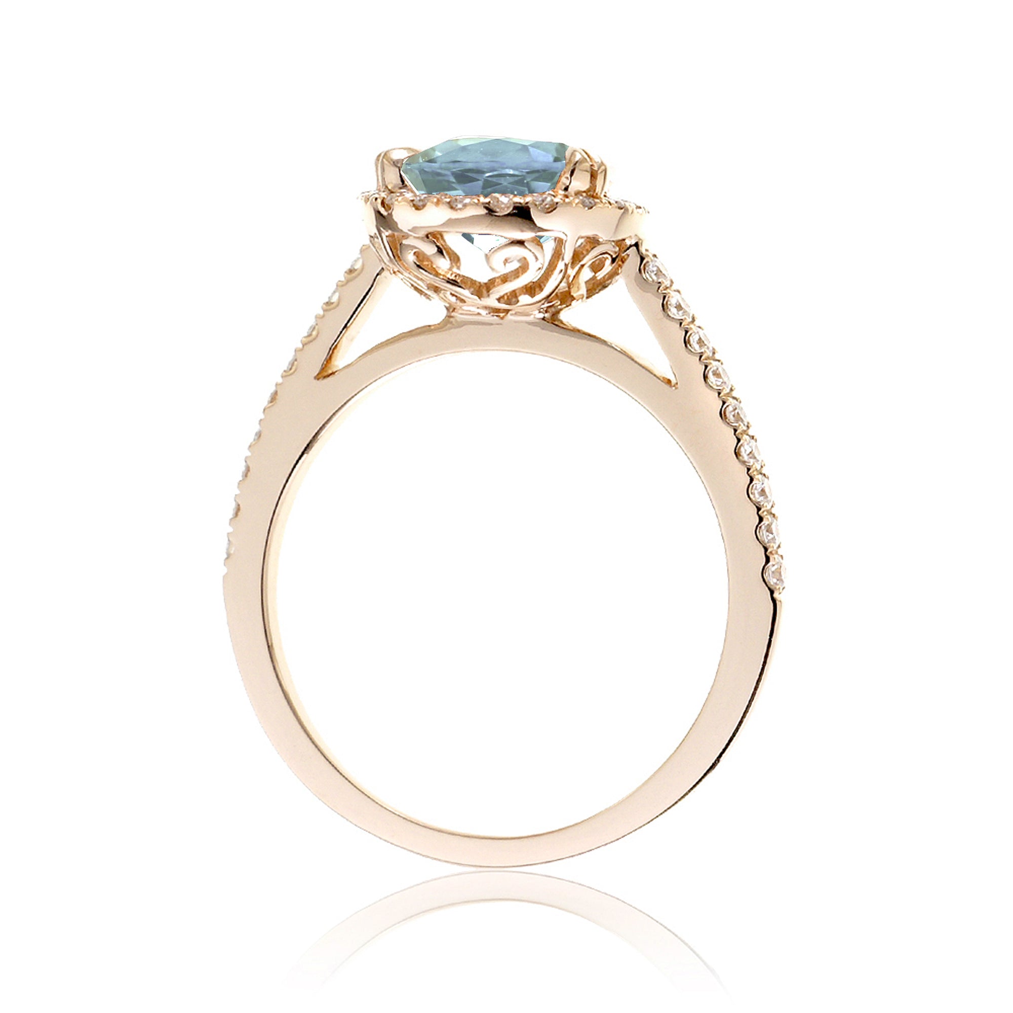 Oval cut aquamarine engagement ring with halo in yellow gold