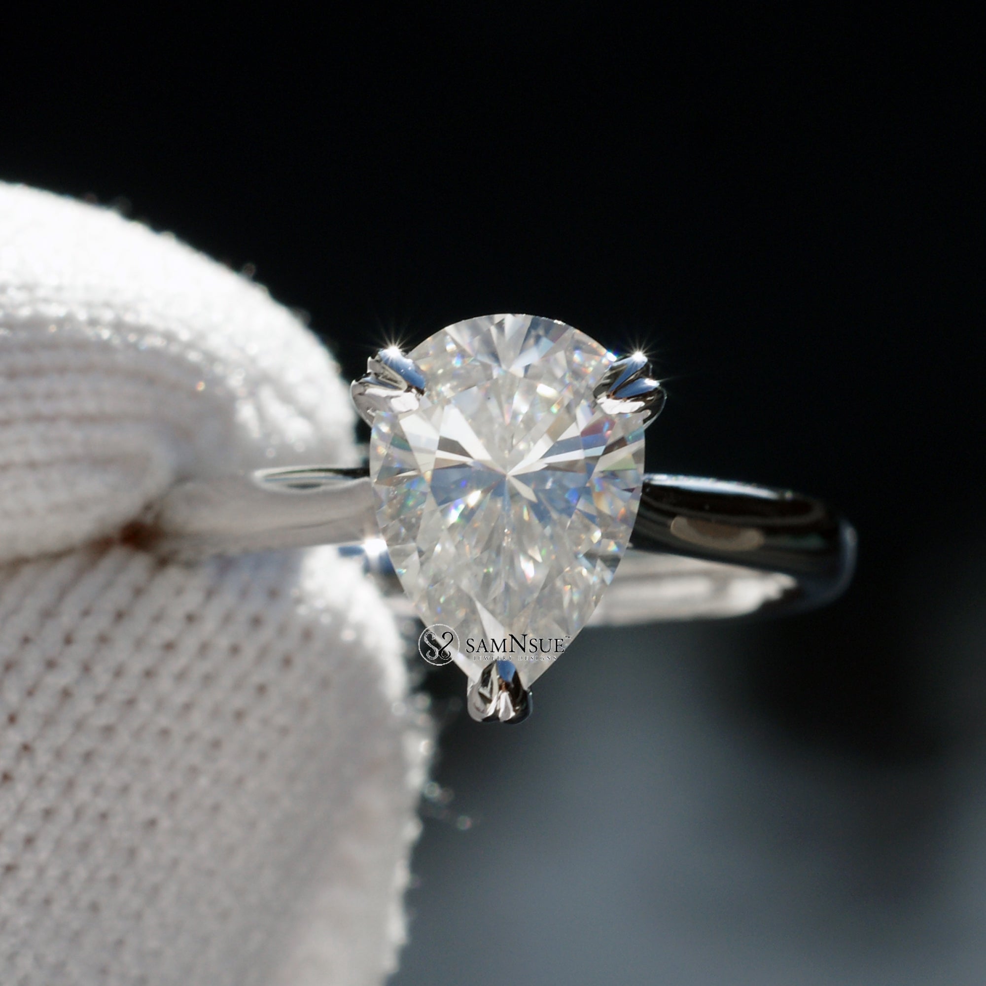 Solitaire pear cut moissanite engagement ring with hidden halo in white gold