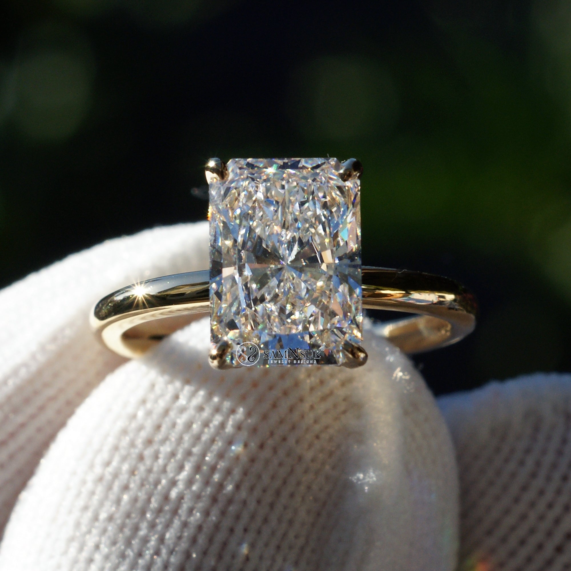 Radiant cut solitaire engagement ring in yellow gold with a hidden halo comfort fit band