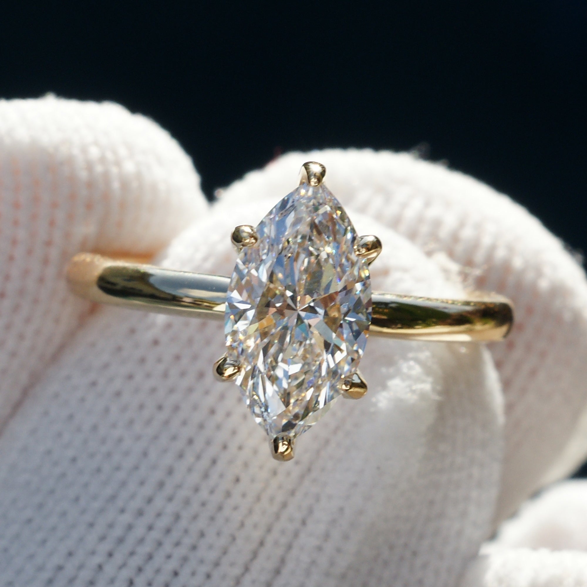 Marquise diamond solitaire engagement ring with hidden halo in yellow gold