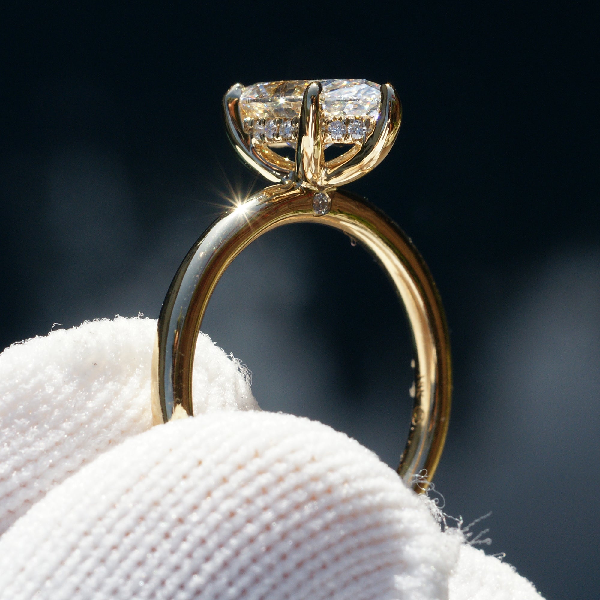 Marquise diamond solitaire engagement ring with hidden halo in yellow gold