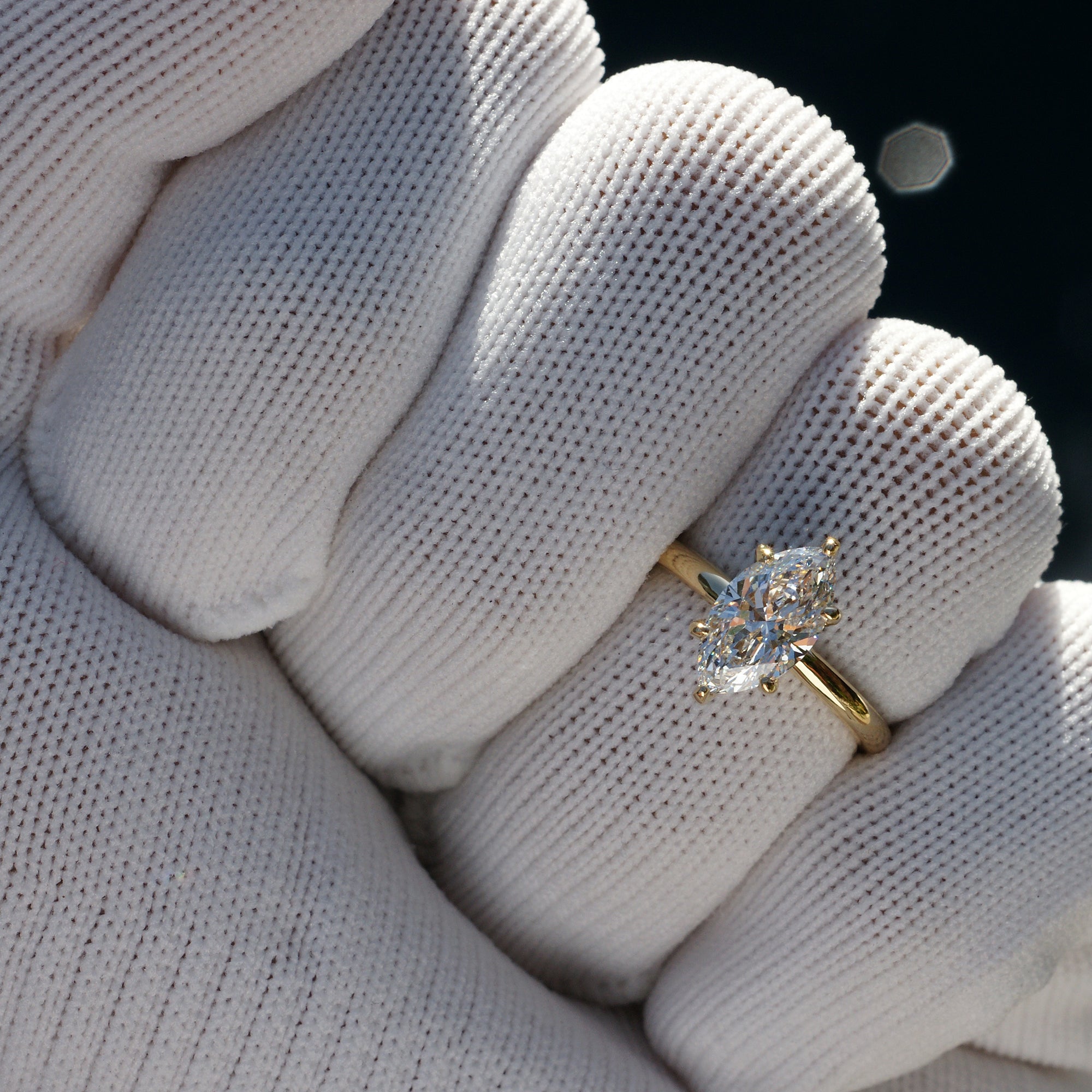 Marquise diamond solitaire engagement ring with hidden halo in yellow gold