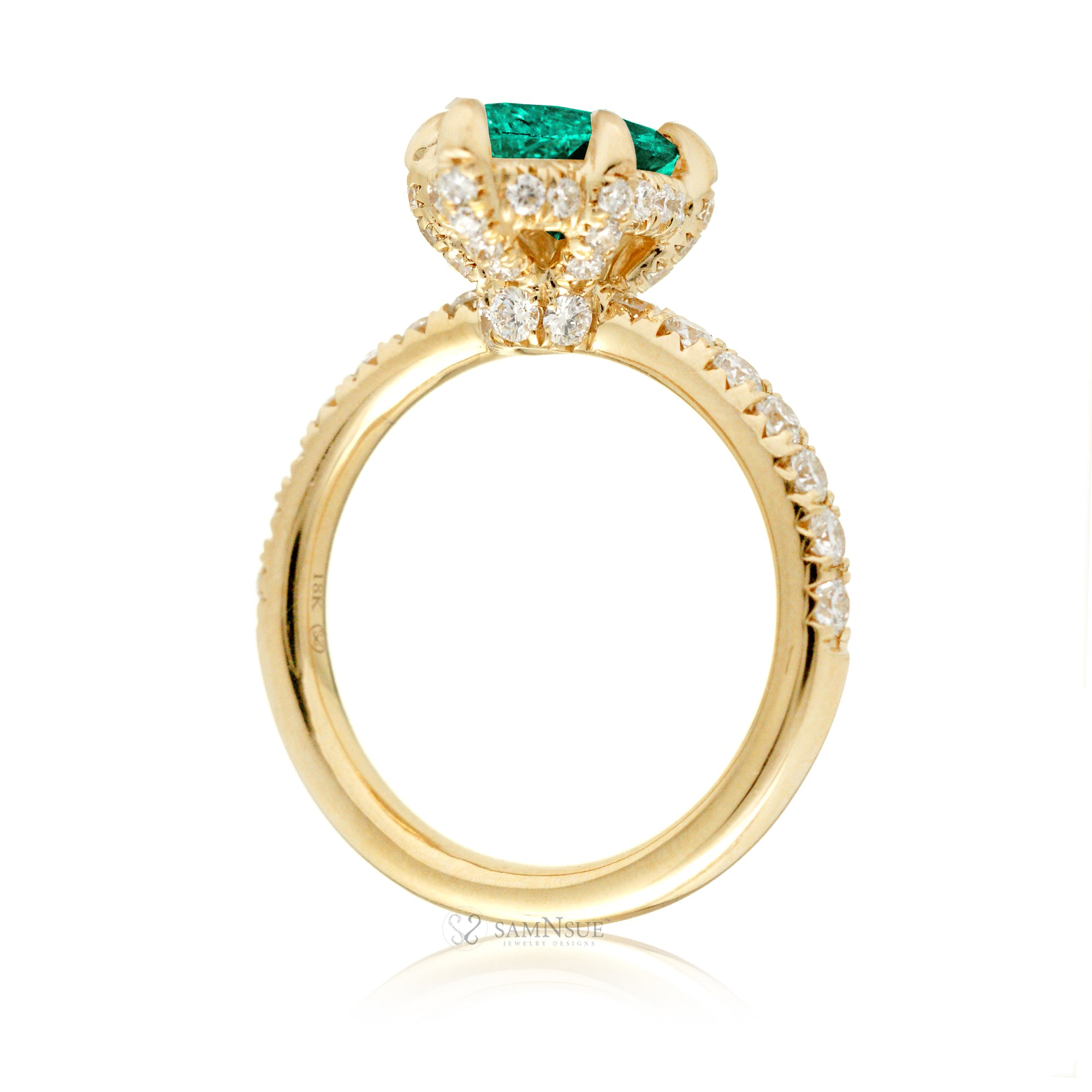 Marquise cut engagement ring with hidden halo and a rounded diamond band in yellow gold