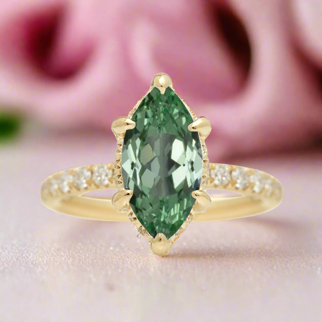 Green sapphire engagement ring with marquise and hidden diamond halo band in yellow gold