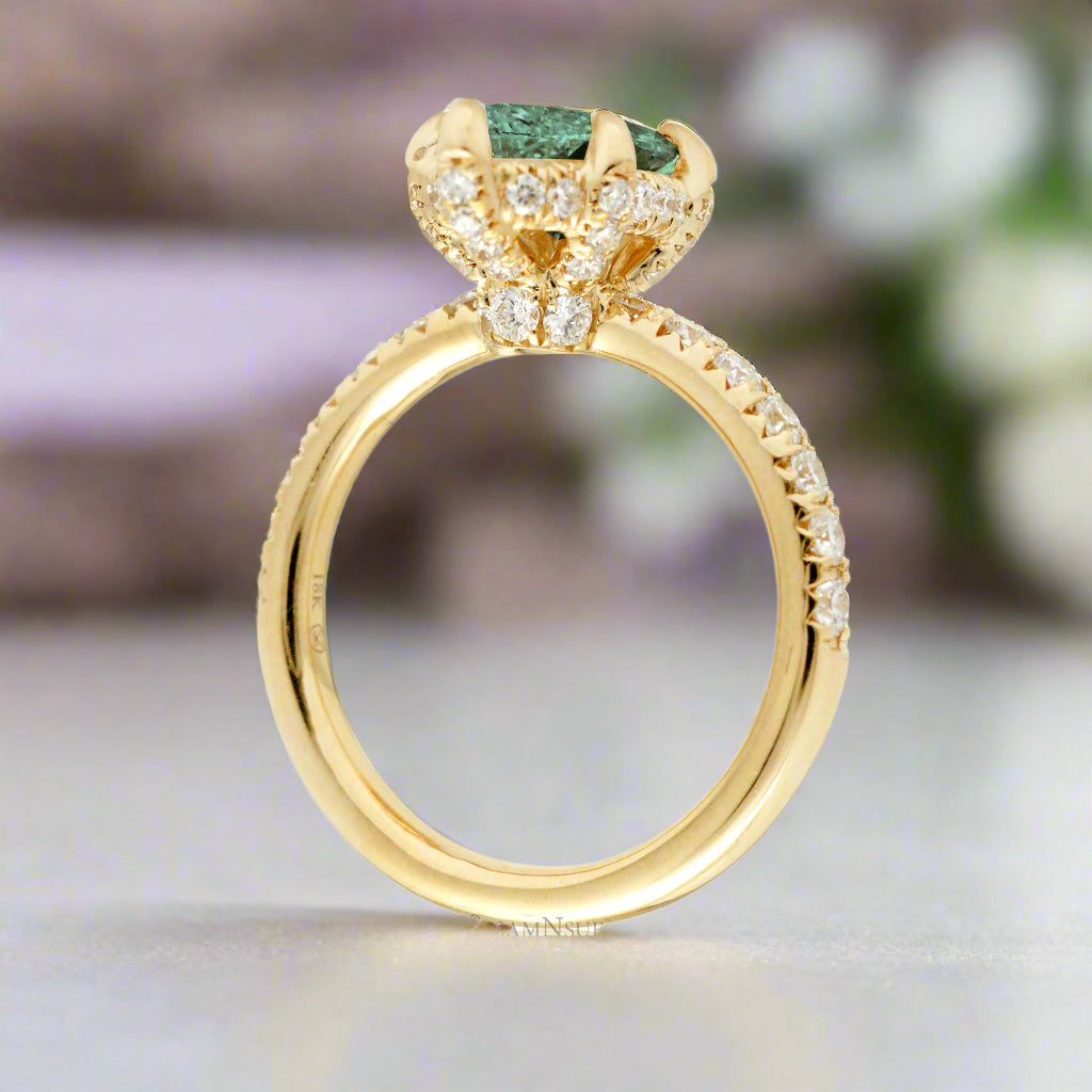 Green sapphire engagement ring with marquise and hidden diamond halo band in yellow gold