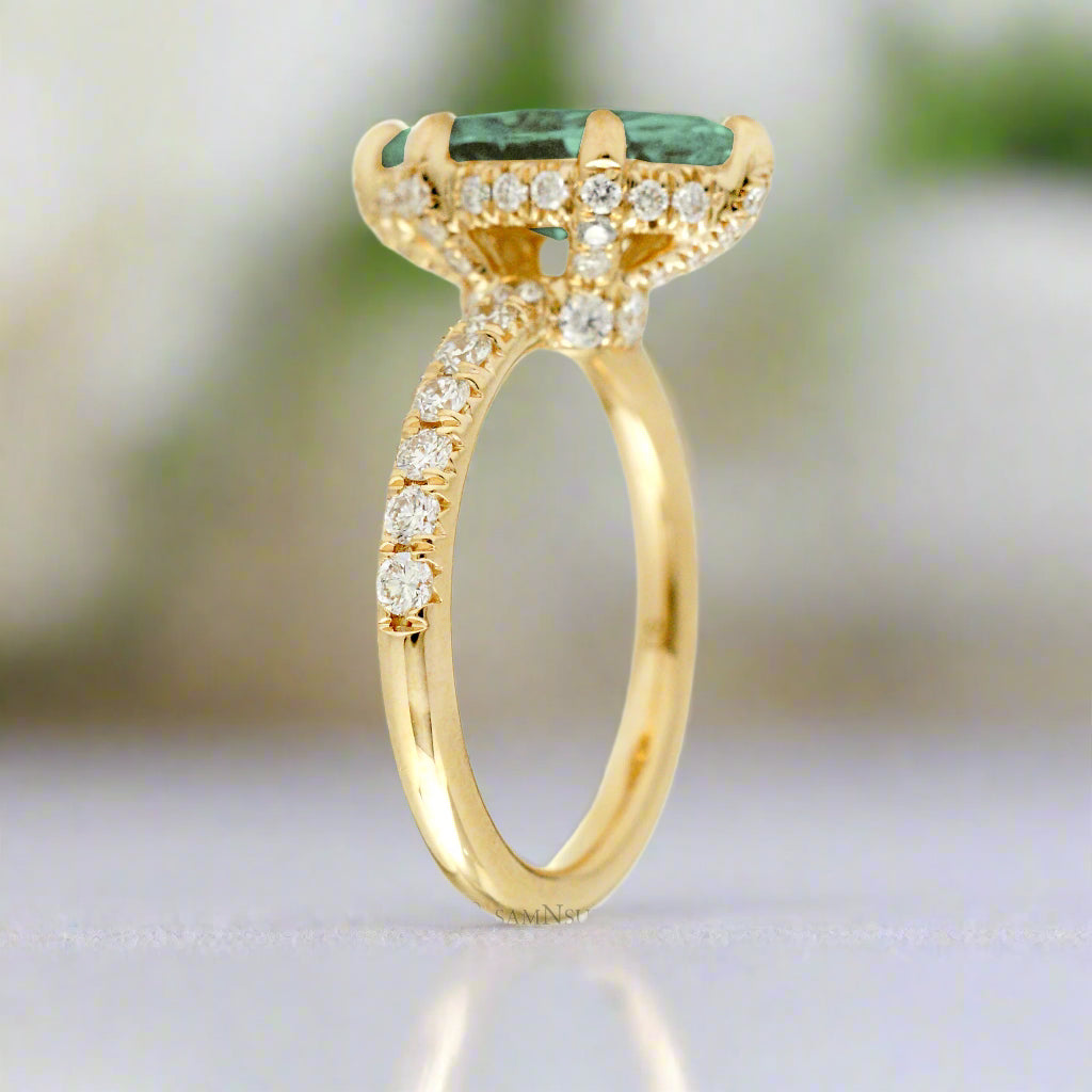 Green sapphire engagement ring with marquise and hidden diamond halo band in yellow gold