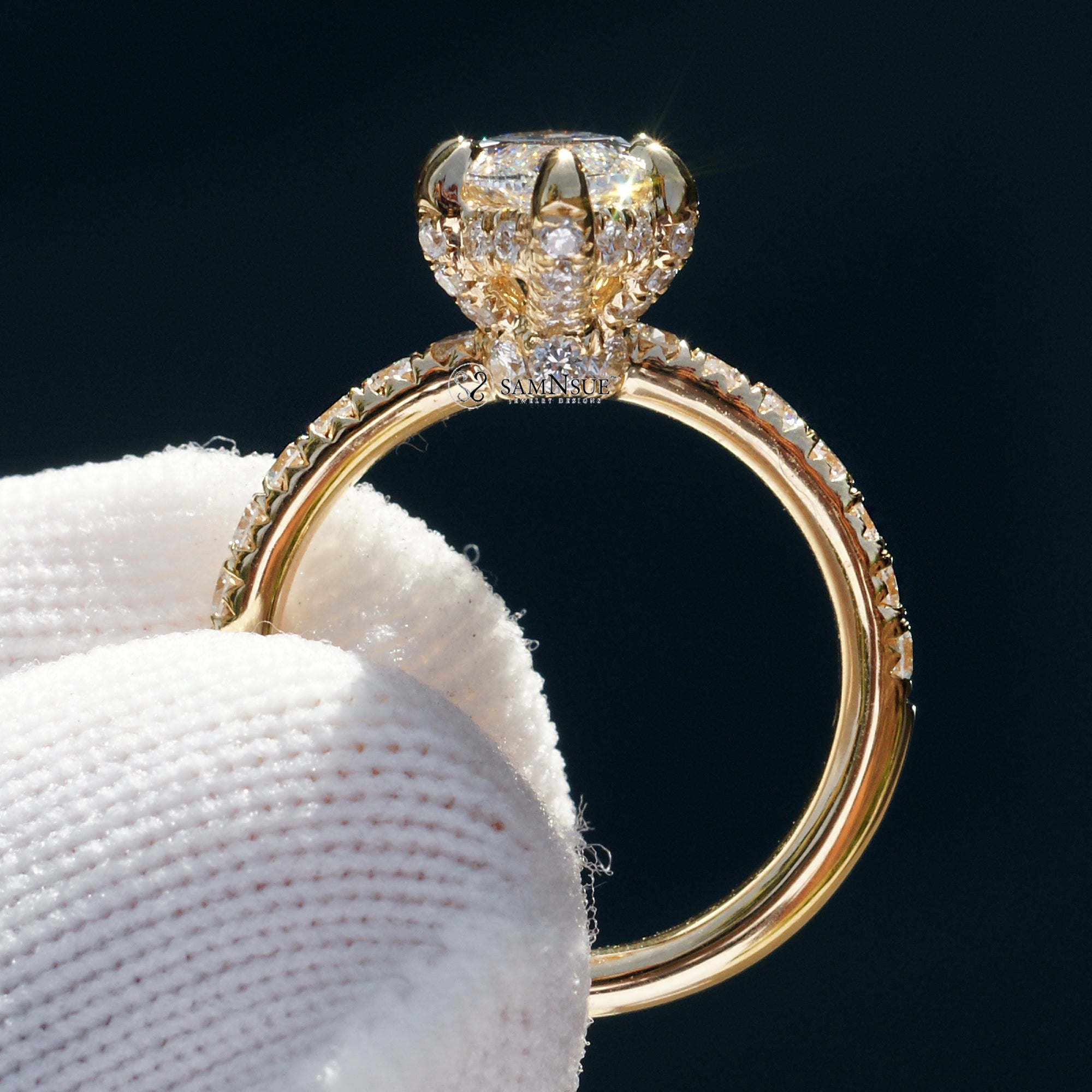 Marquise cut diamond engagement ring with drenched prongs hidden halo and rounded diamond band in yellow gold