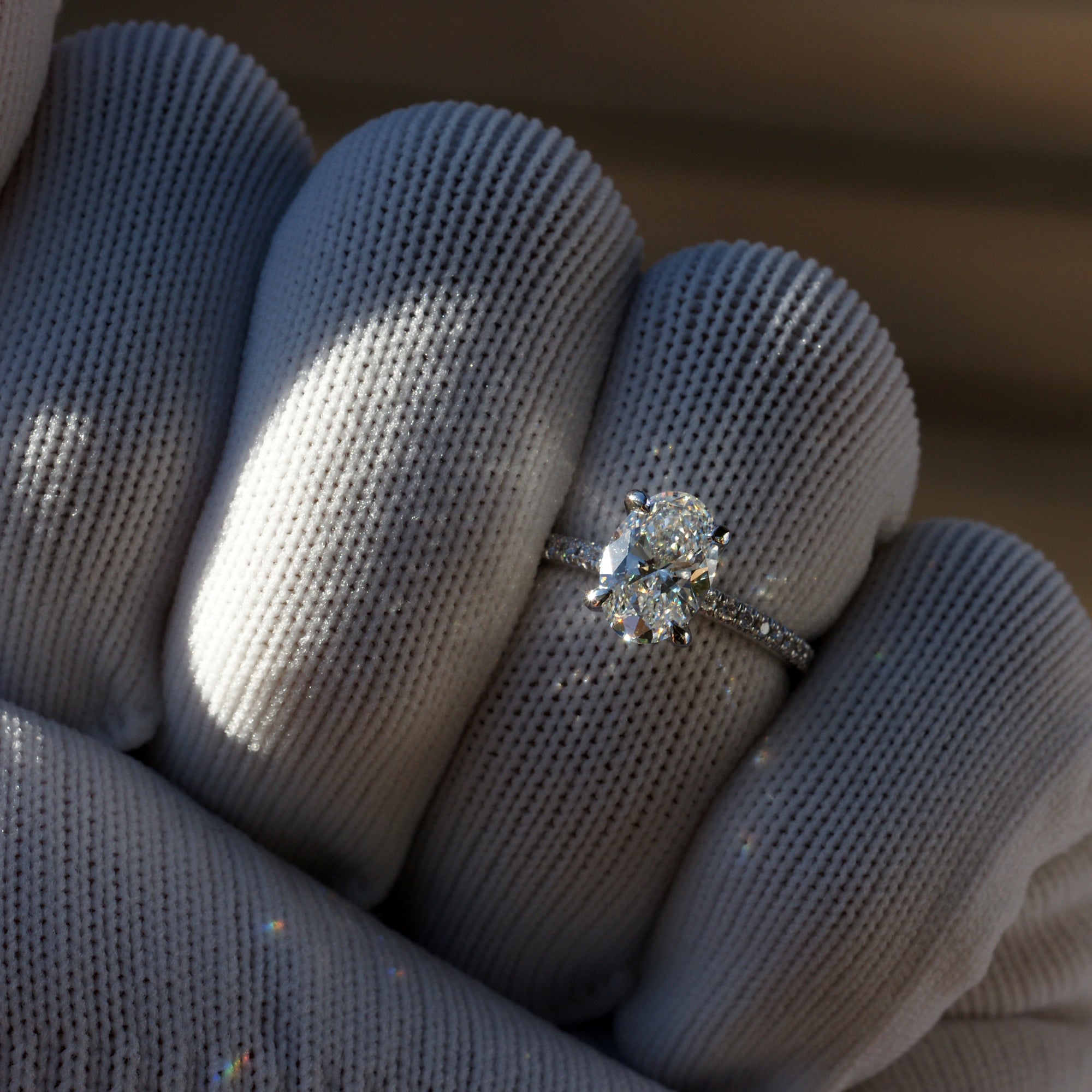 Oval diamond engagement ring in platinum with 1.5 carat center stone and  1.8mm diamond band