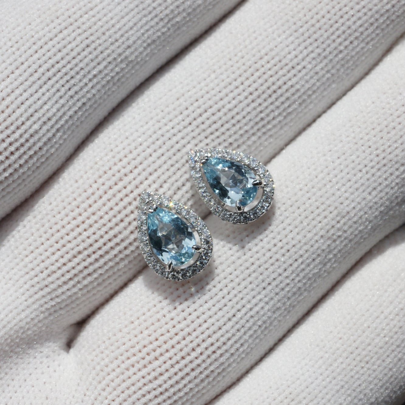 Pear cut aquamarine teardrop and diamond halo stud earrings in white gold