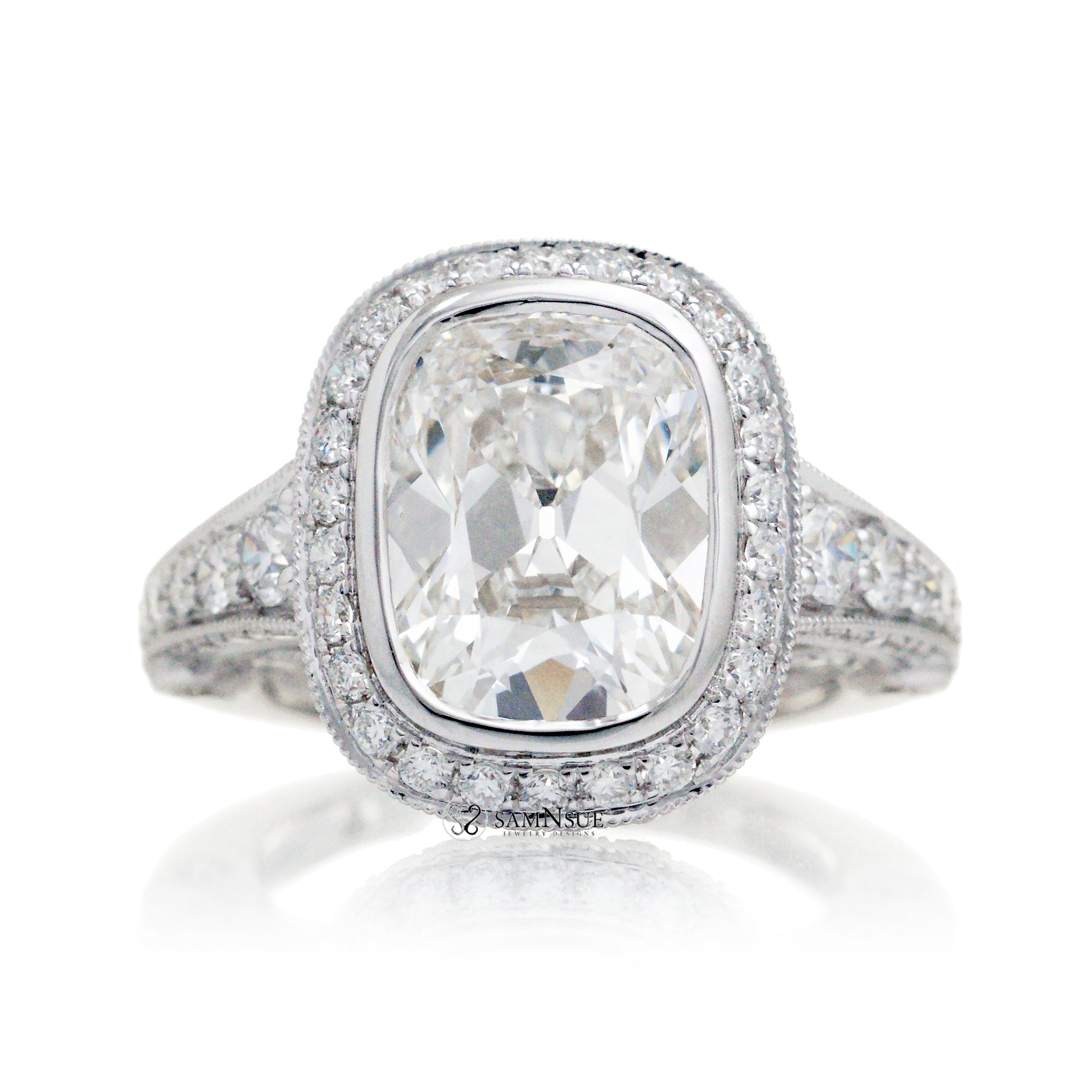 Old miner cut diamond engagement ring with halo and bezel setting