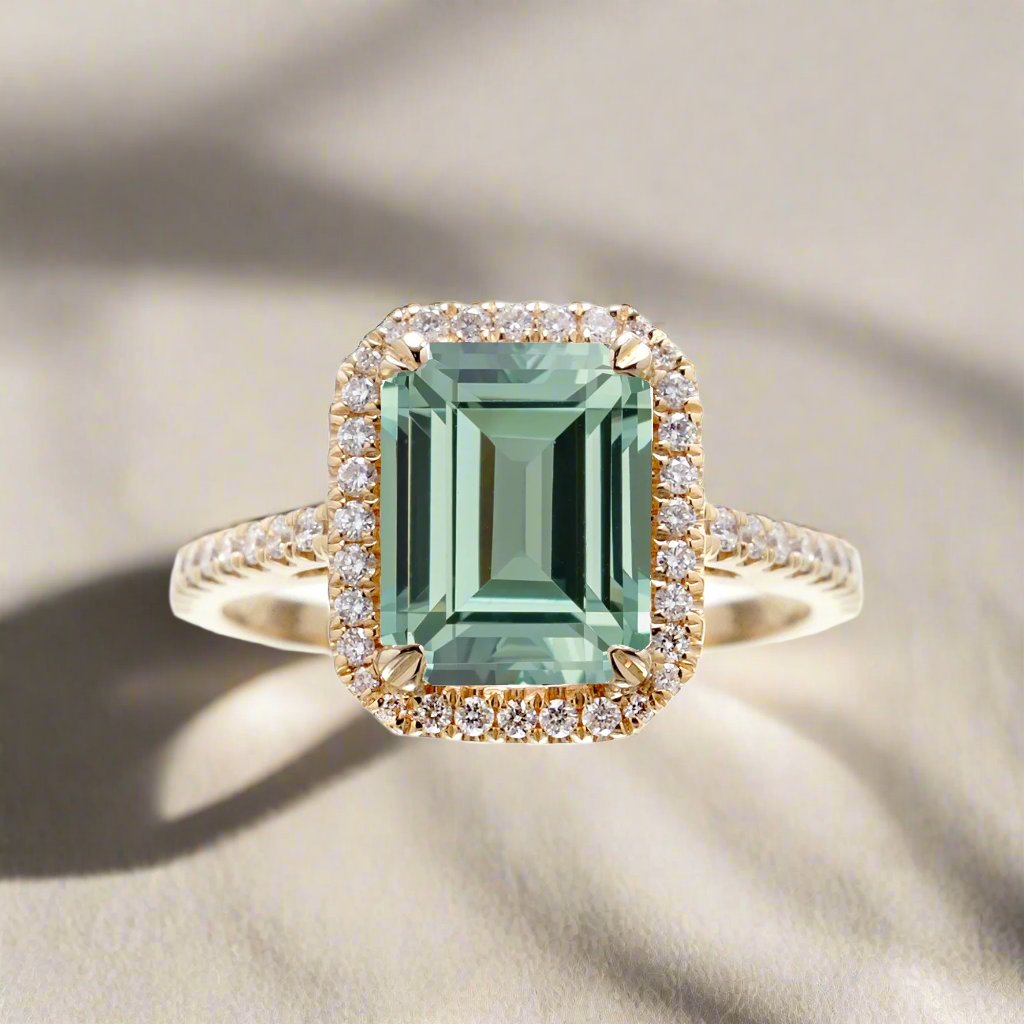 Green emerald step cut engagement ring in yellow gold