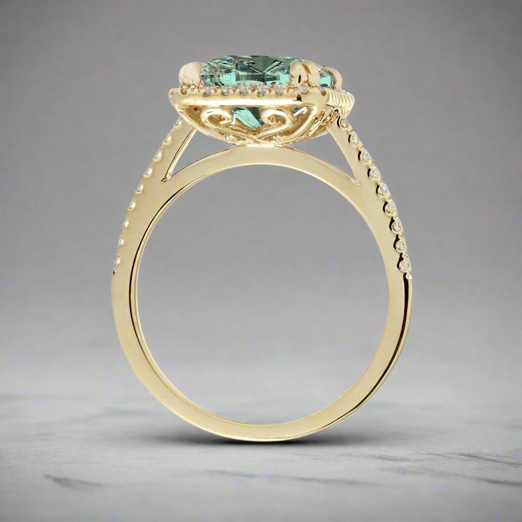 Green emerald step cut engagement ring in yellow gold