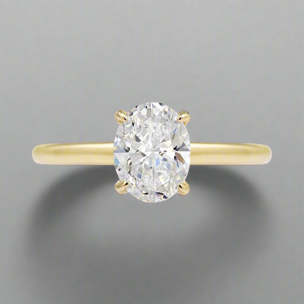 Oval diamond engagement ring solid band hidden halo in yellow gold