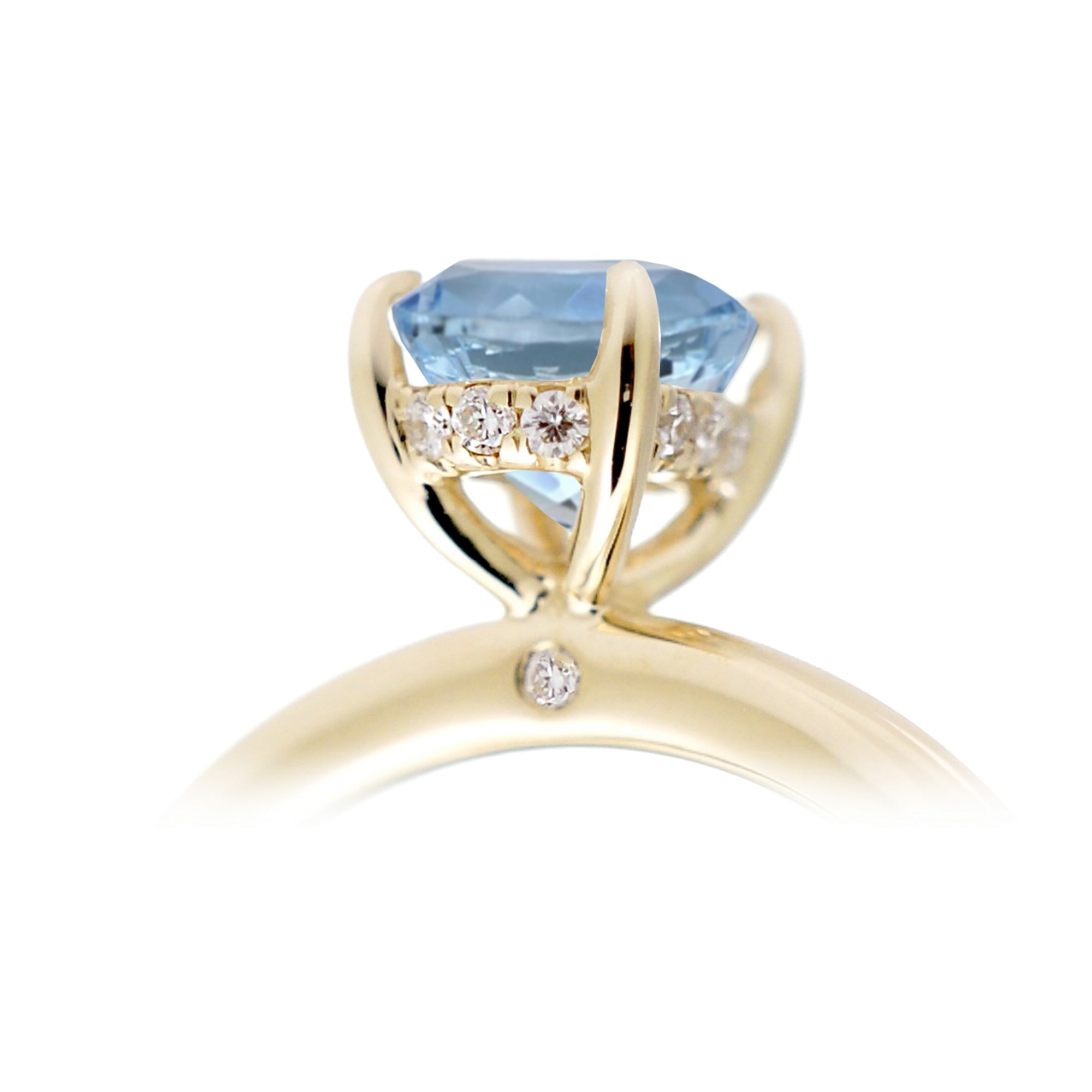 Round aquamarine ring with a diamond hidden halo in yellow gold