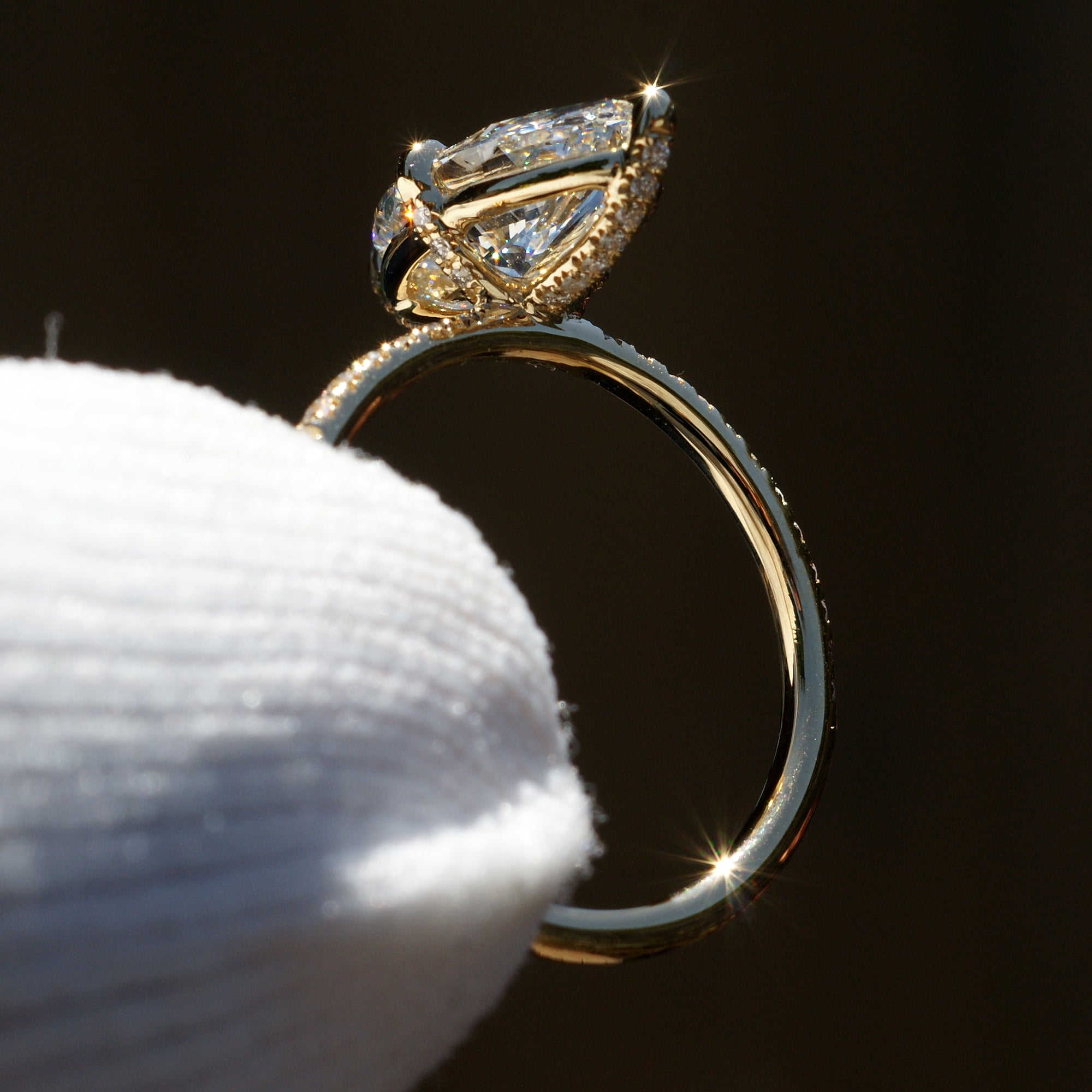 Marquise diamond engagement ring in yellow gold accent diamond on prongs