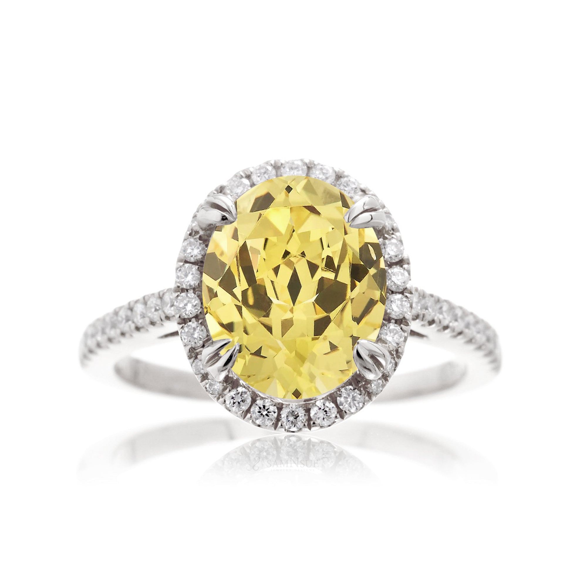 Oval cut yellow sapphire engagement ring with a diamond halo in white gold