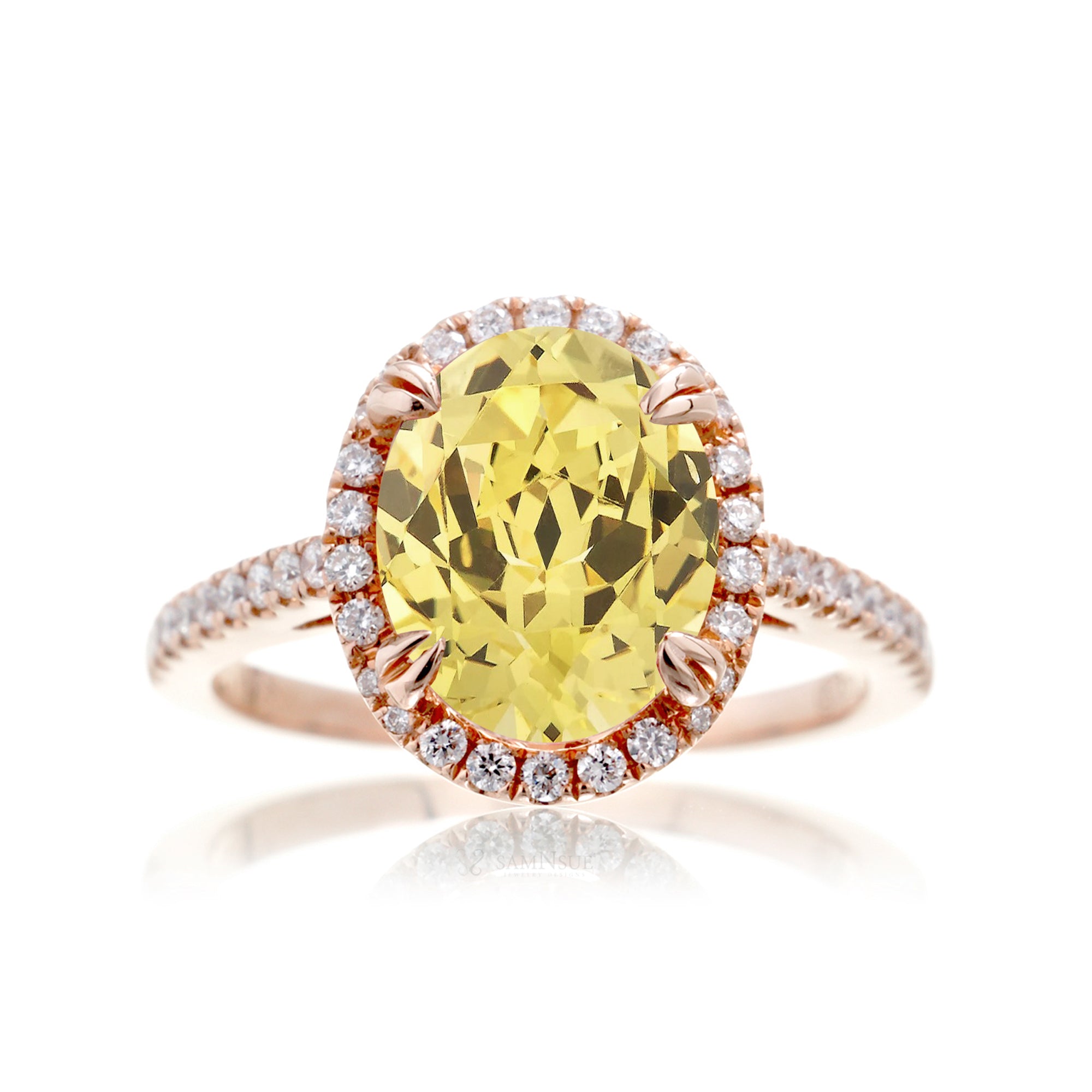 Oval cut yellow sapphire engagement ring with a diamond halo in rose gold