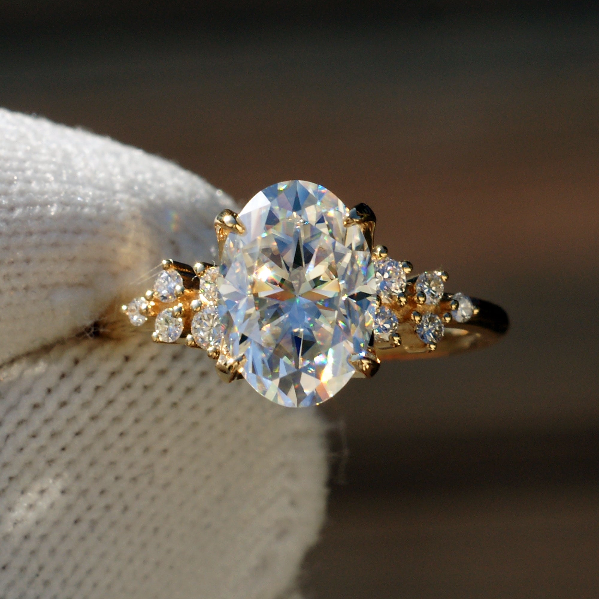 Oval solitaire moissanite engagement ring with side diamonds The Stella yellow gold