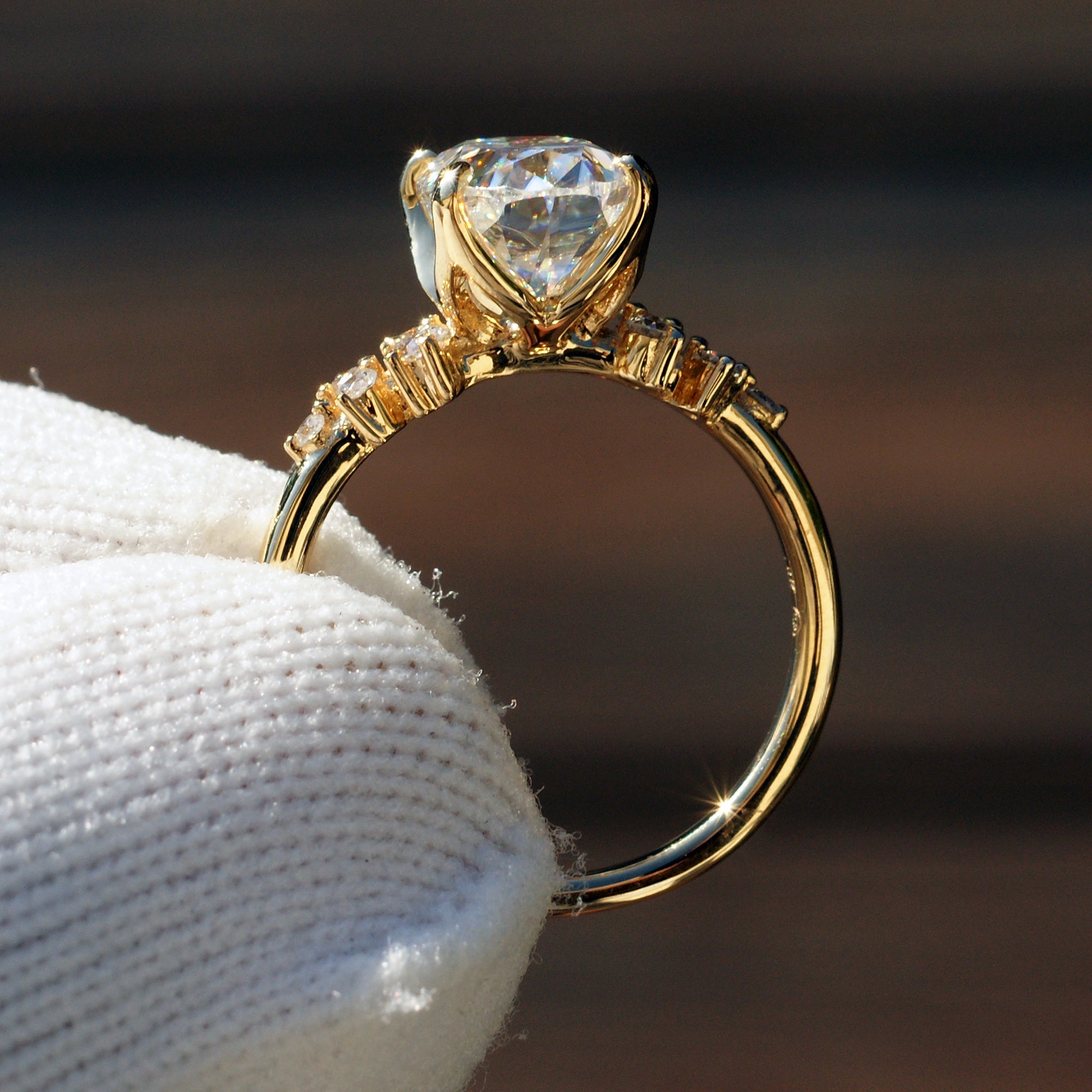 Oval solitaire moissanite engagement ring with side diamonds The Stella yellow gold