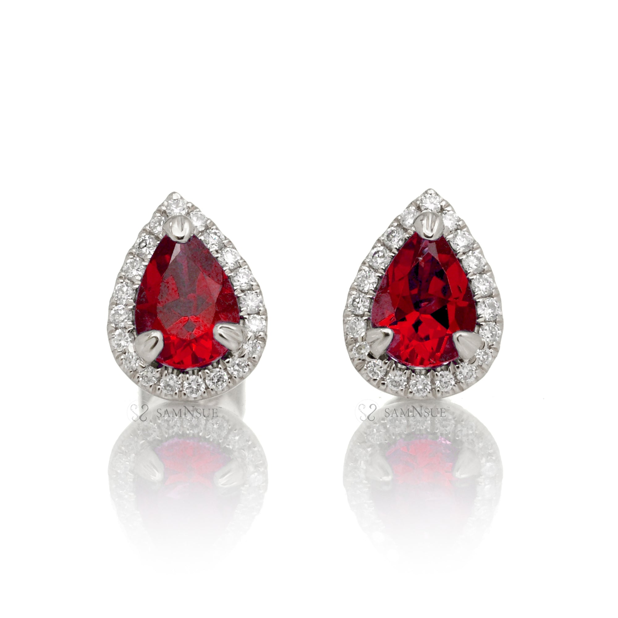 Pear ruby stud with diamond halo in white gold