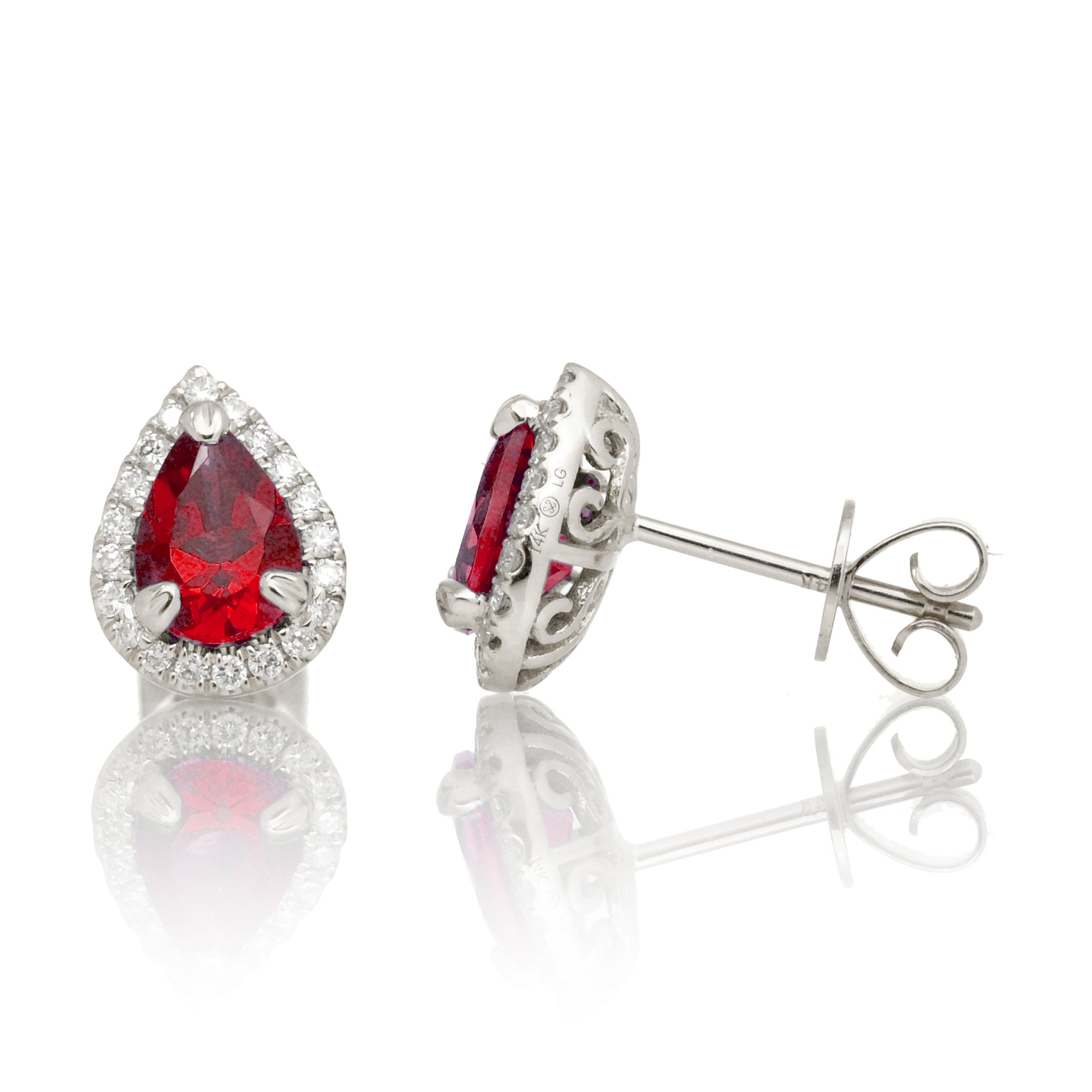 Pear ruby stud with diamond halo in white gold