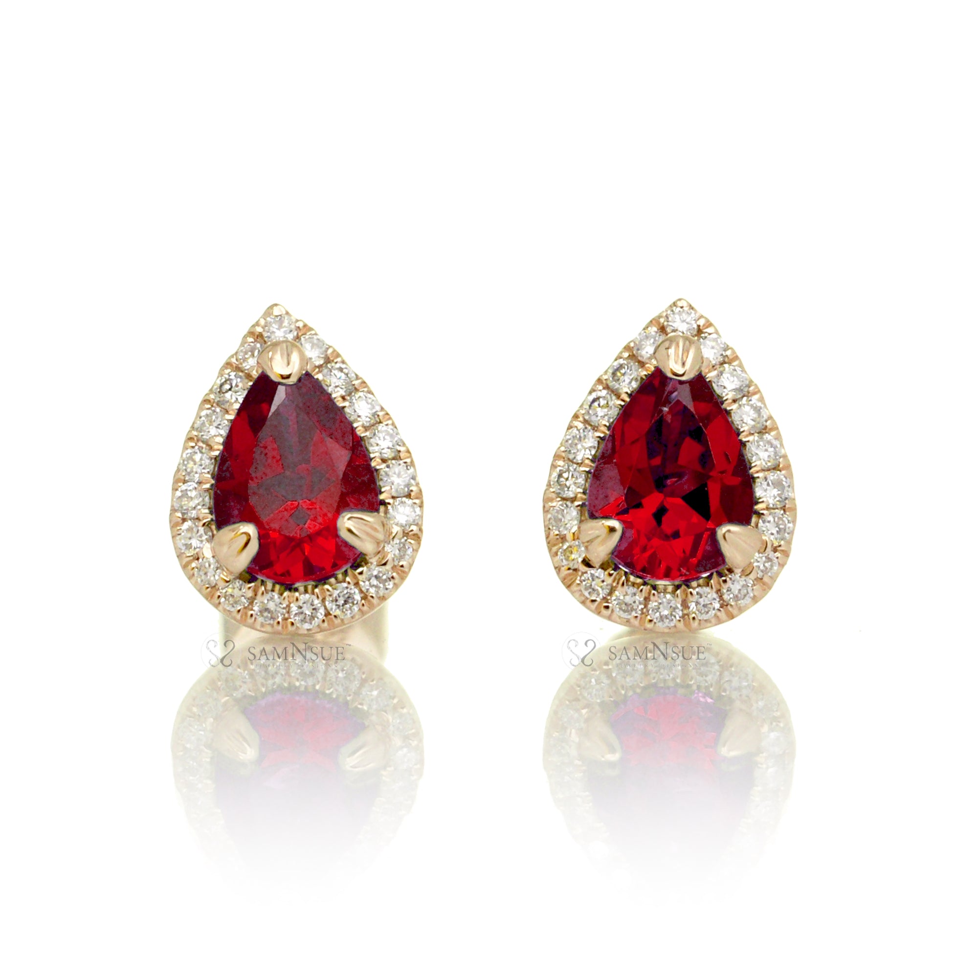 Pear ruby stud with diamond halo in yellow gold