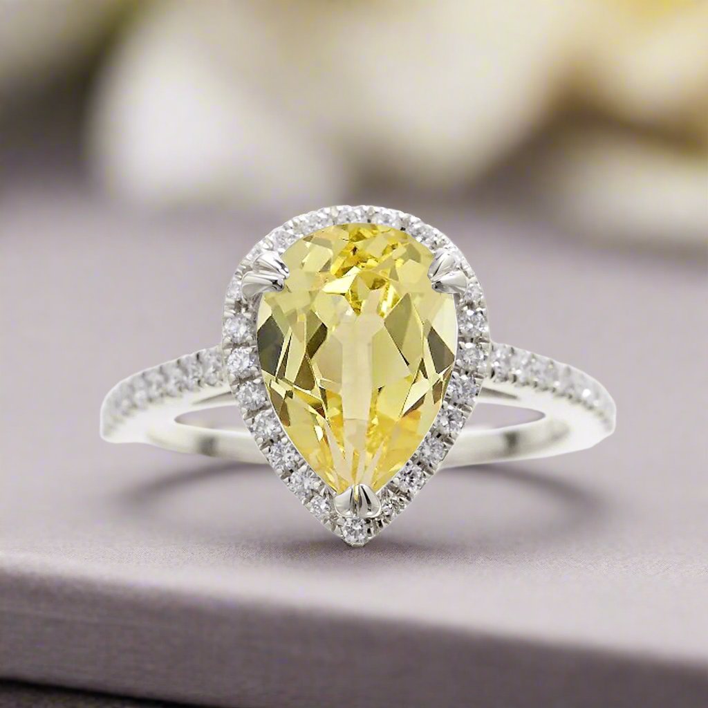 Pear yellow sapphire engagement ring with diamond halo 