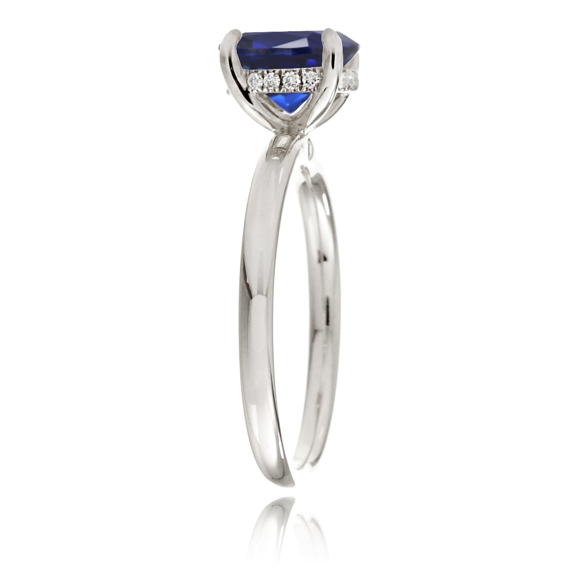 Round cut blue lab-grown sapphire with diamond hidden halo on white gold