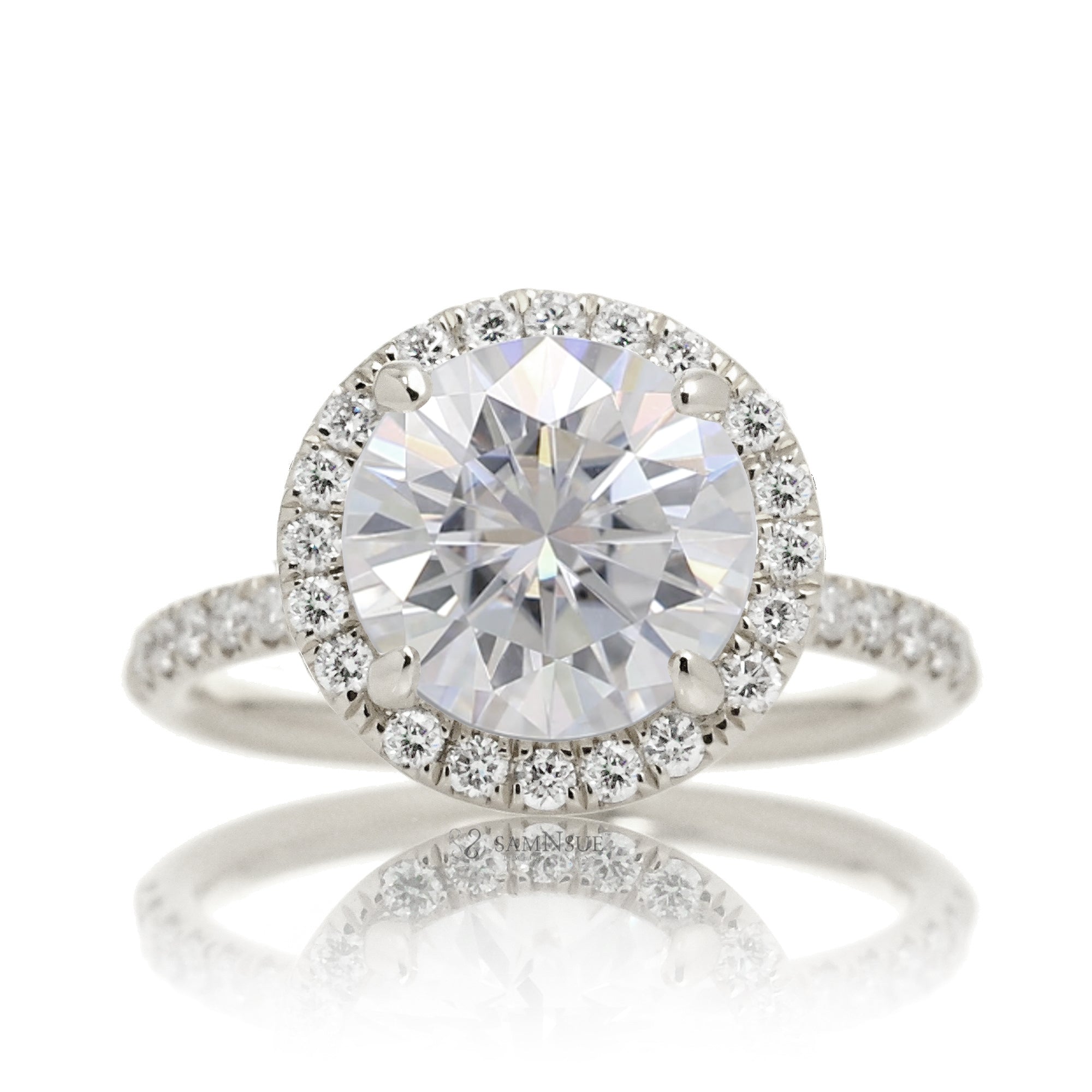 Round brilliant cut moissanite engagement ring with a diamond halo the Drenched white gold