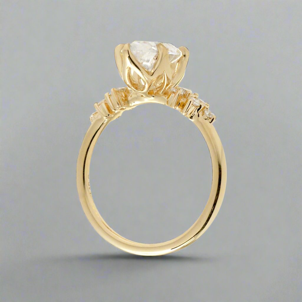 Marquise cut moissanite crown basket and diamond side stone ring yellow gold