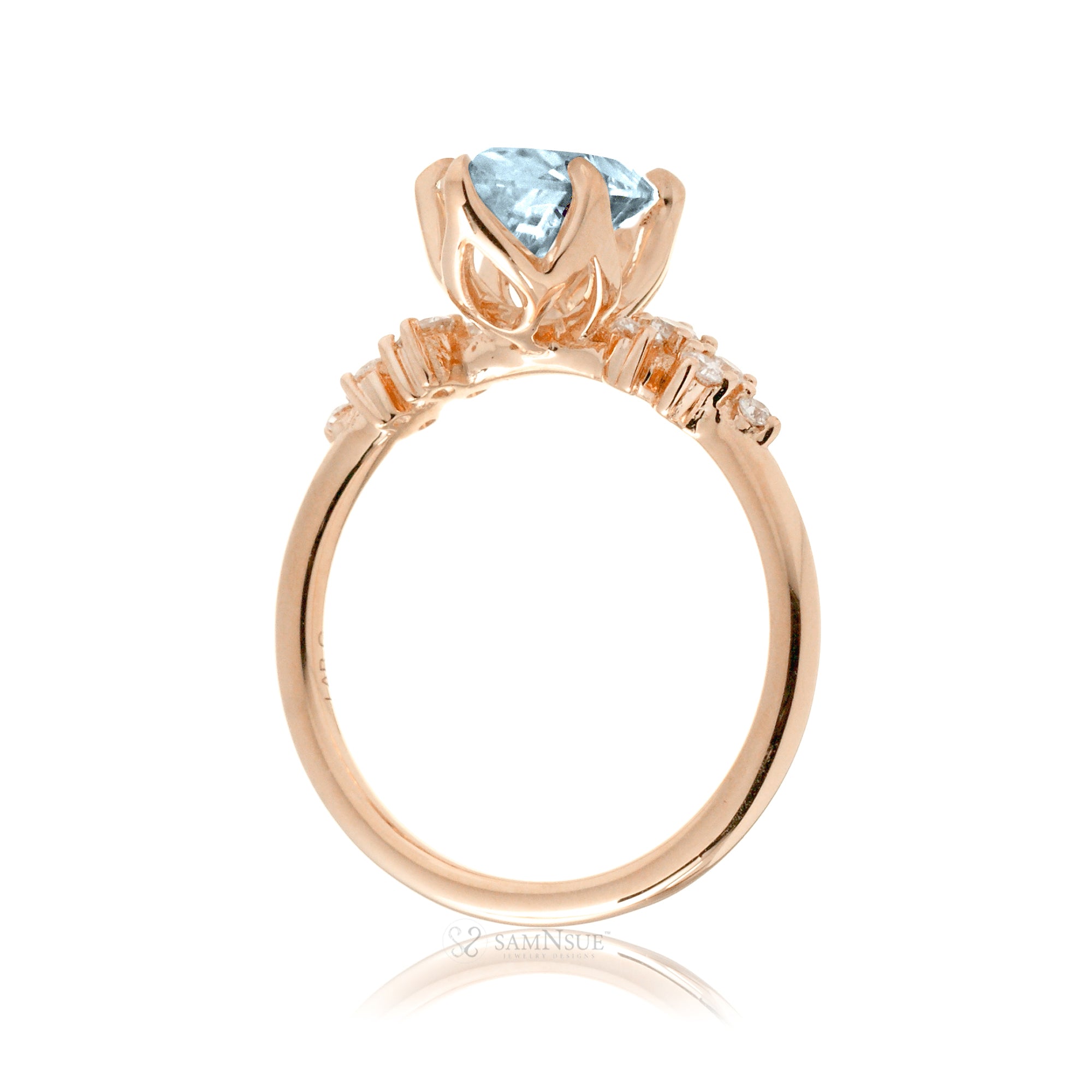 Aquamarine ring with oval center stone and side accent diamonds in rose gold