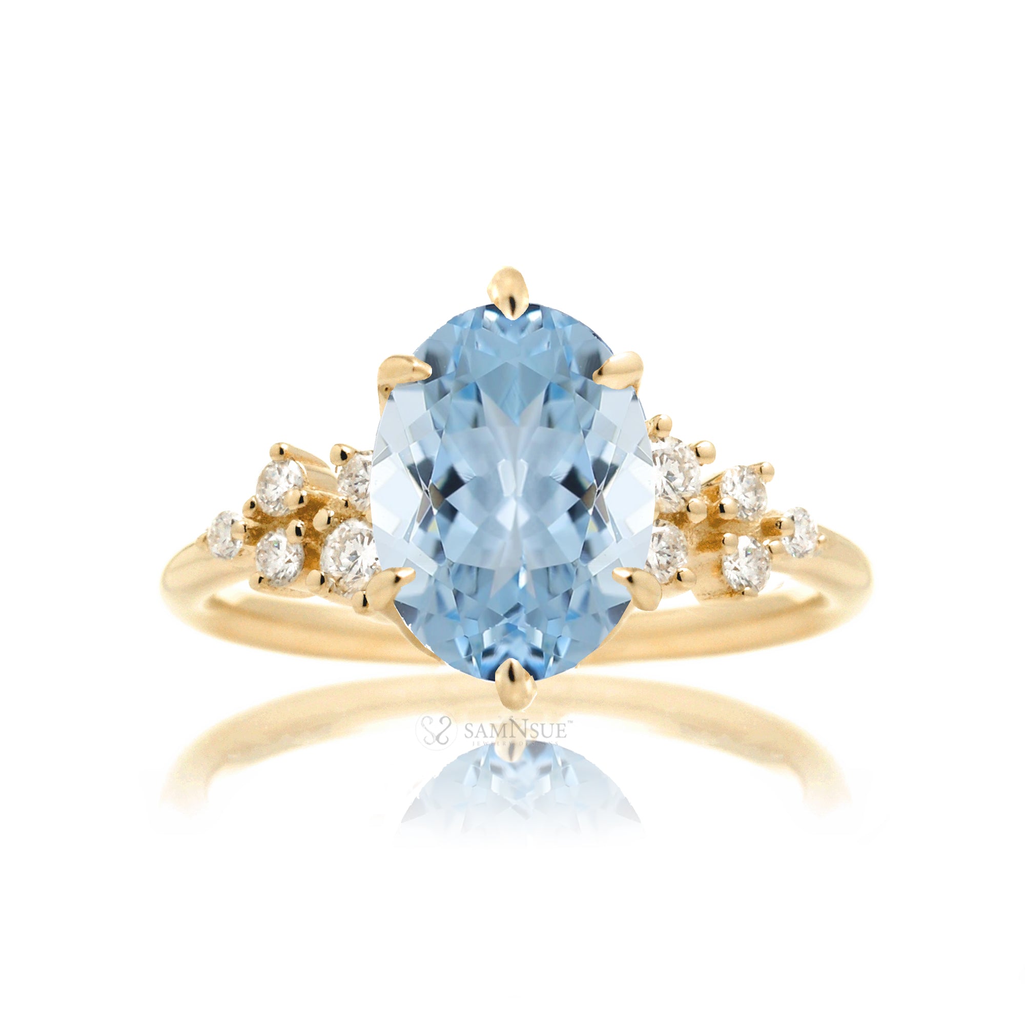 Aquamarine ring with oval center stone and side accent diamonds in yellow gold