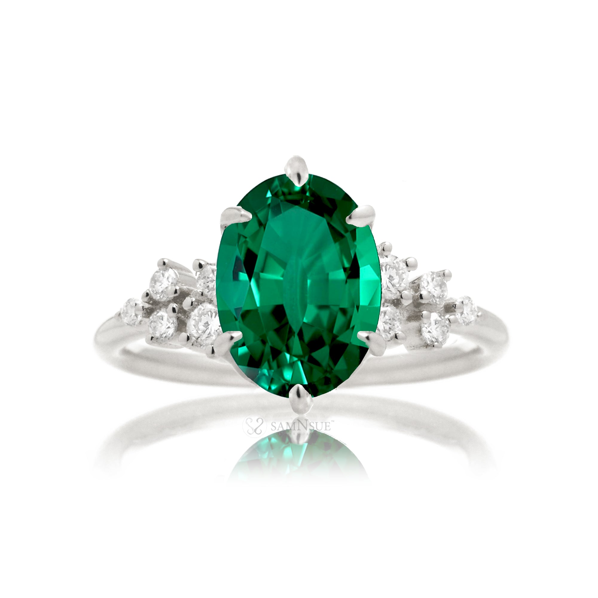 Oval emerald ring with diamond accent on white gold