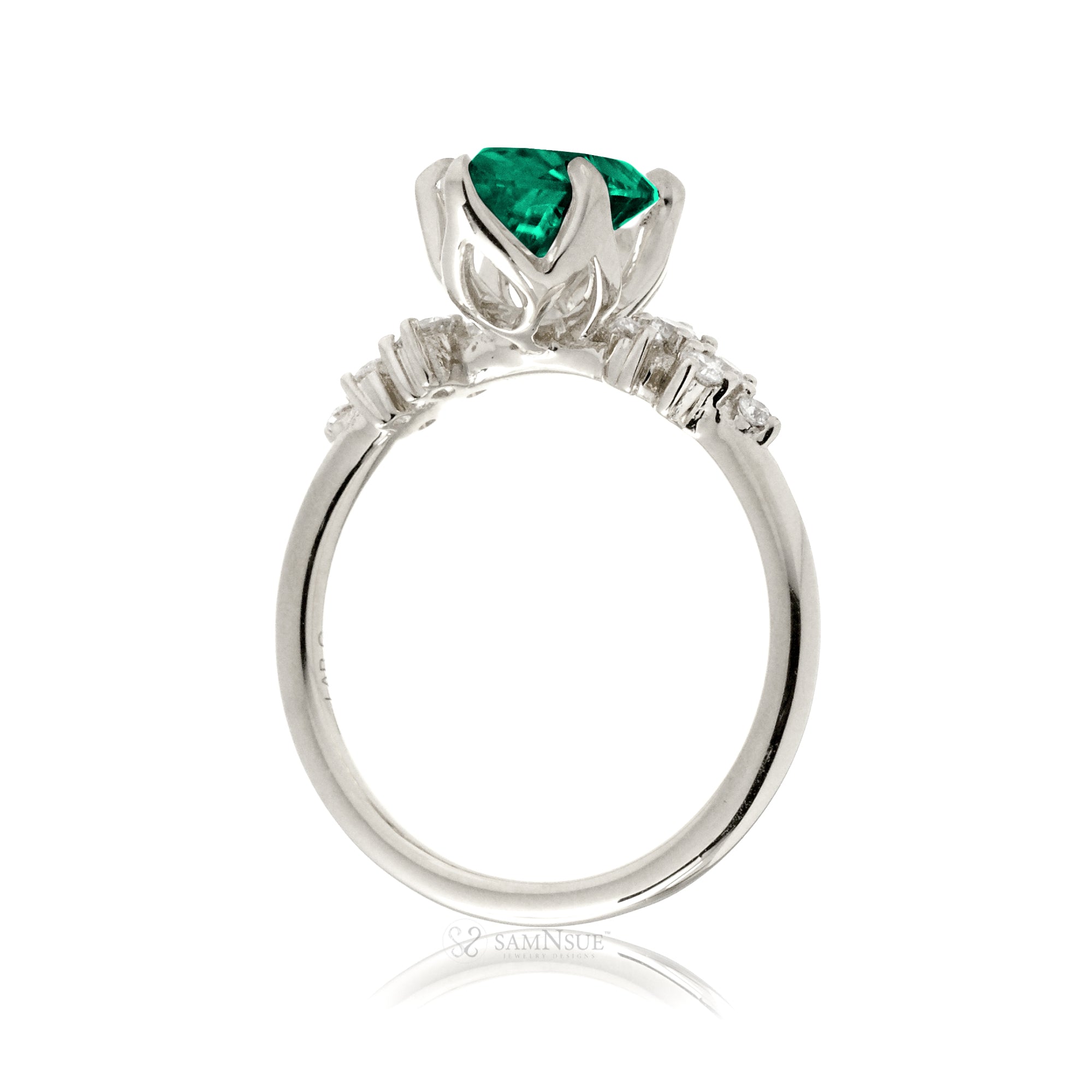 Oval emerald ring with diamond accent on white gold