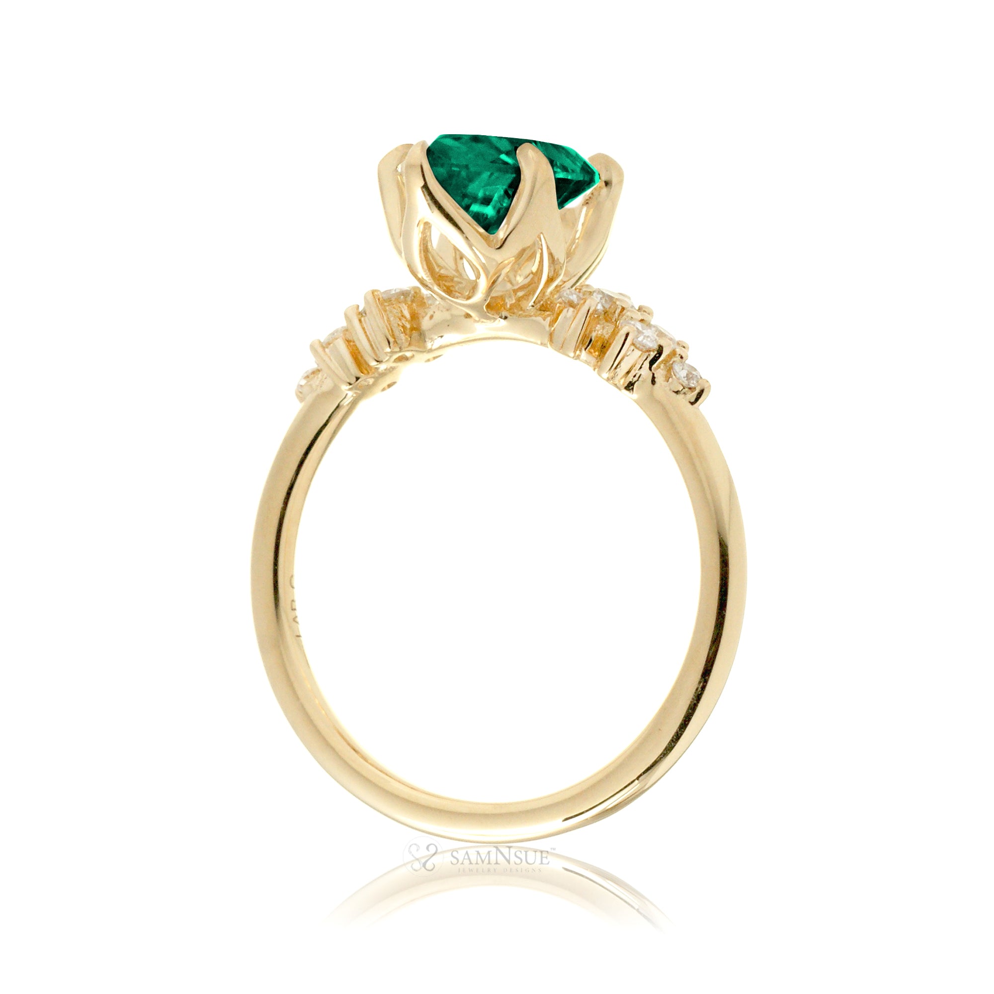Oval emerald ring with diamond accent on yellow gold