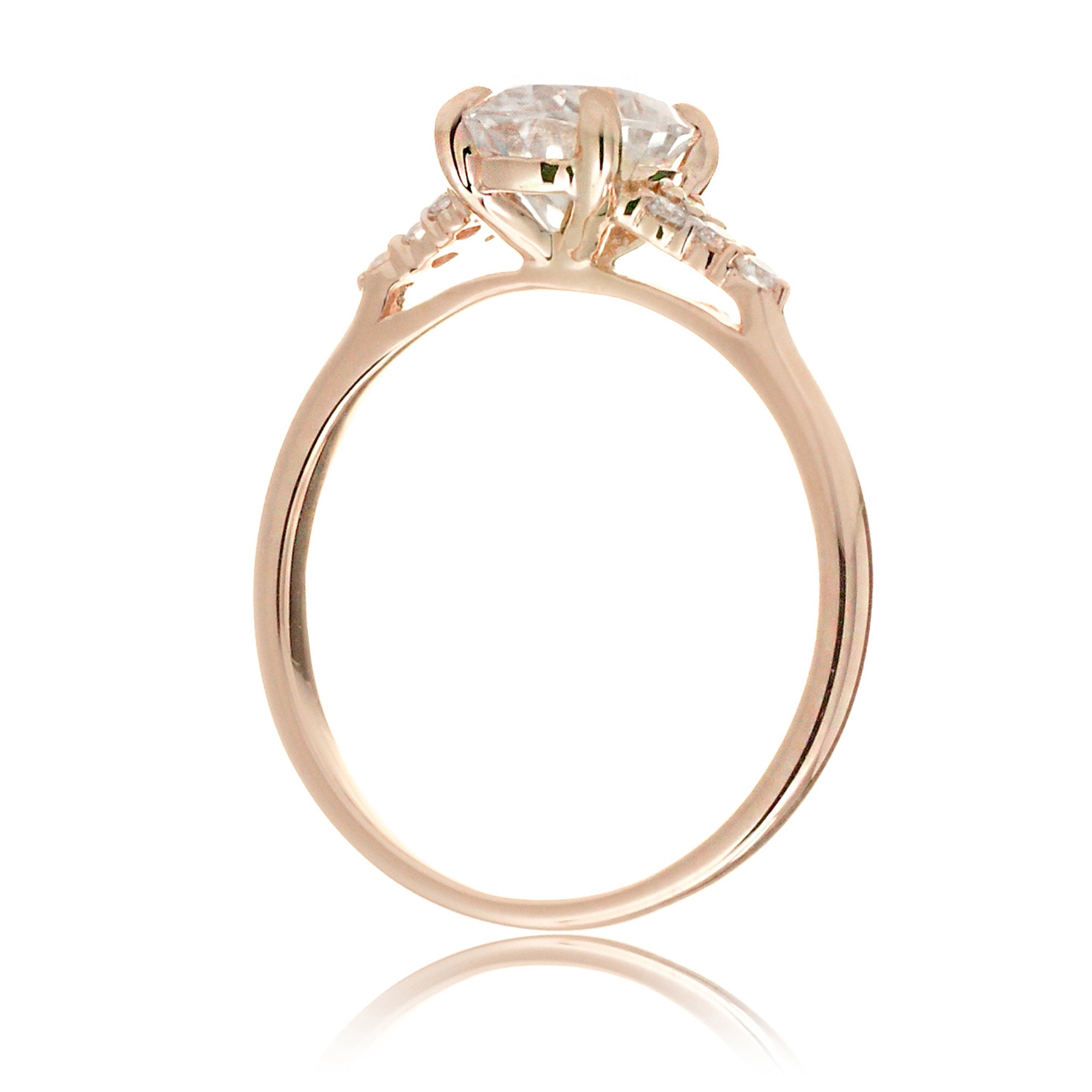 Emerald cut moissanite three stone diamond ring in rose gold