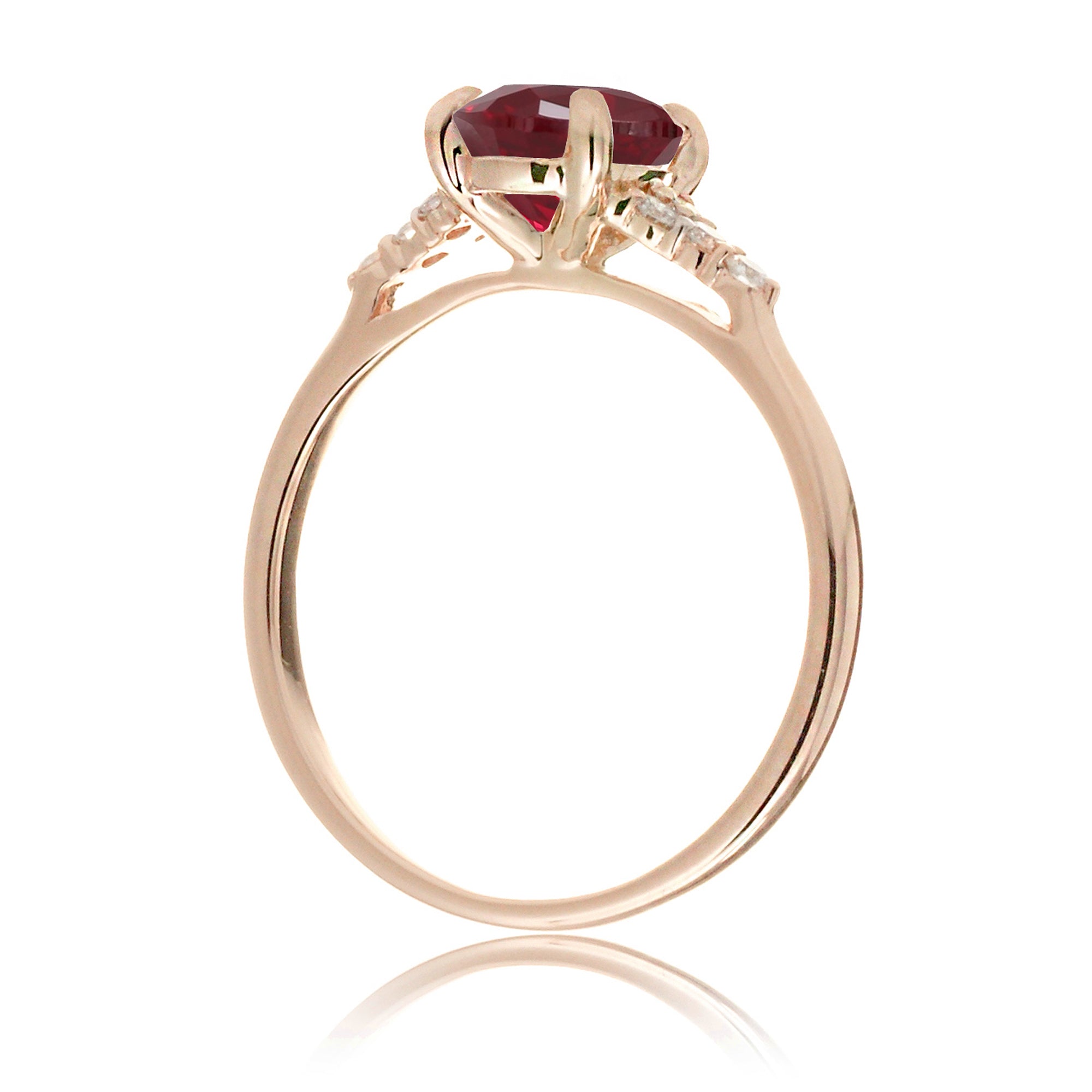 Emerald cut ruby and diamond three stone ring in rose gold