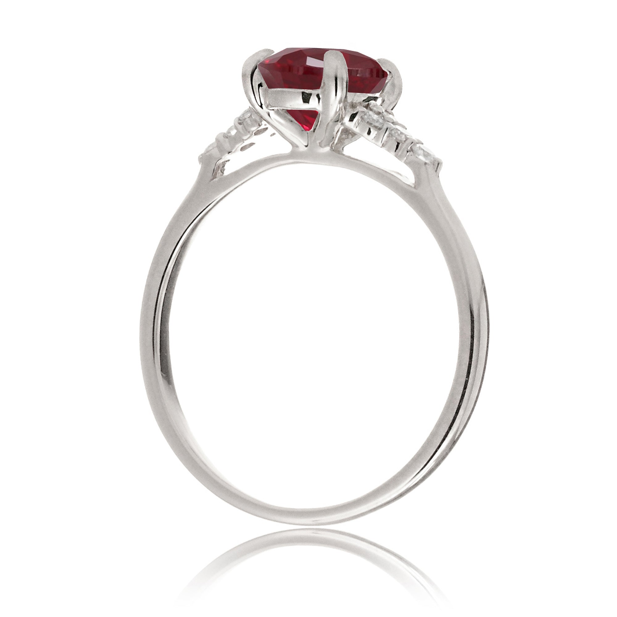 Emerald cut ruby and diamond three stone ring in white gold