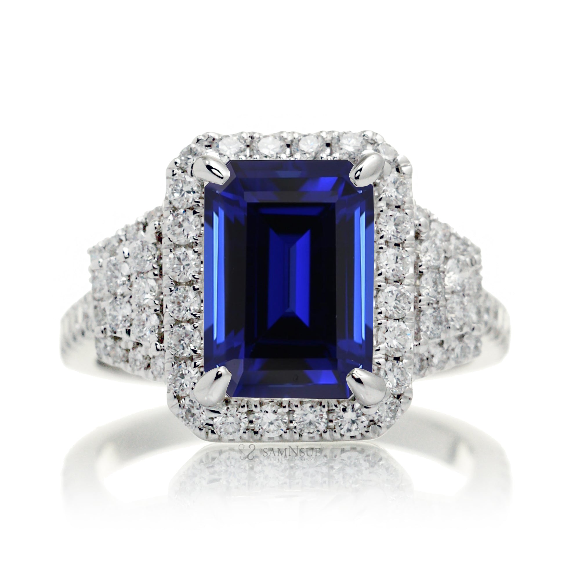 Emerald cut blue sapphire diamond halo and trapezoid three stone ring white gold