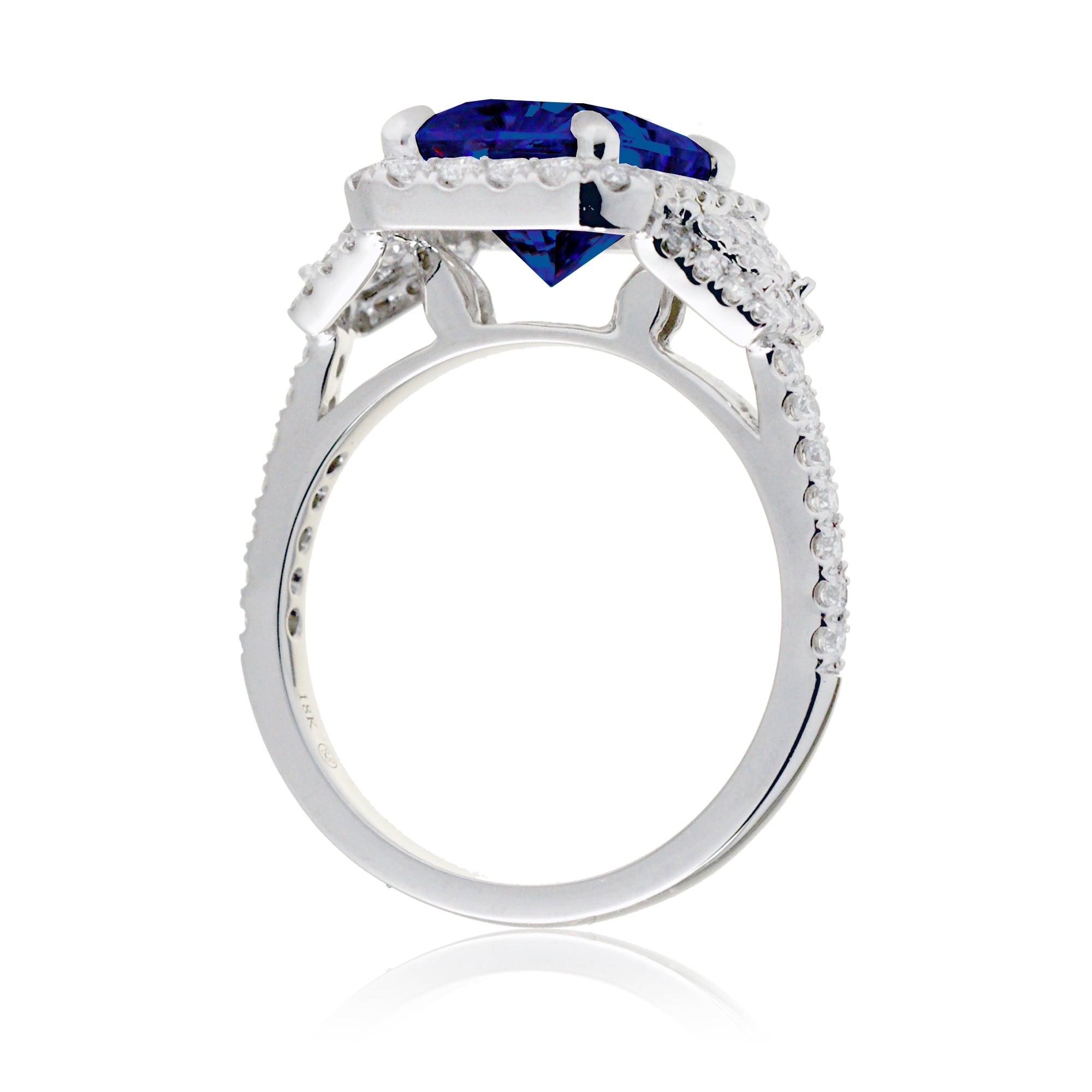 Emerald cut blue sapphire diamond halo and trapezoid three stone ring white gold