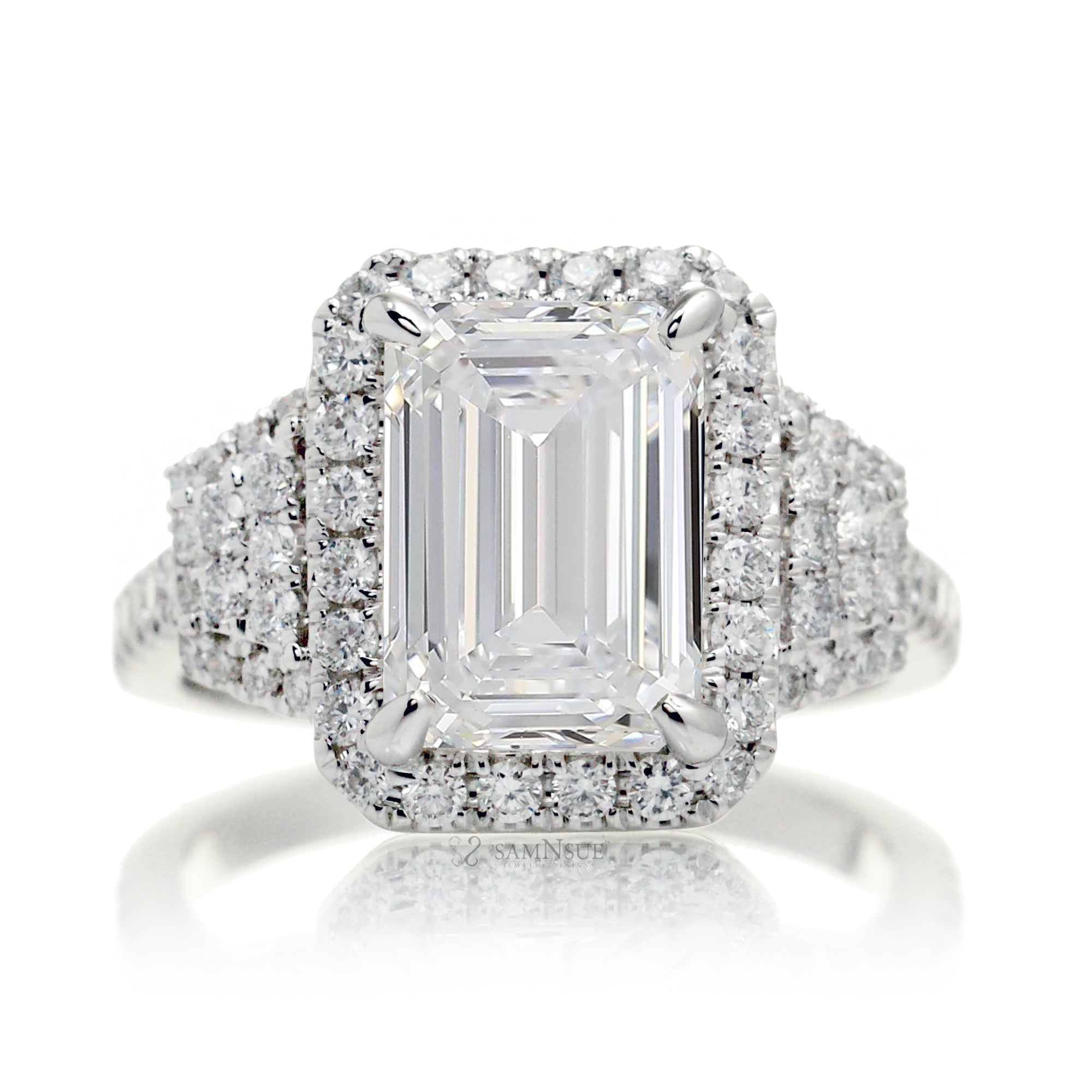 Emerald cut three stone diamond ring with trapezoid side shape in white gold