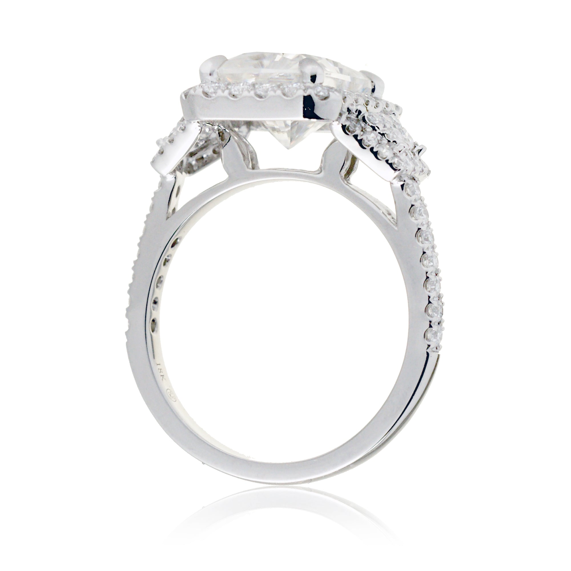 Emerald cut three stone diamond ring with trapezoid side shape in white gold