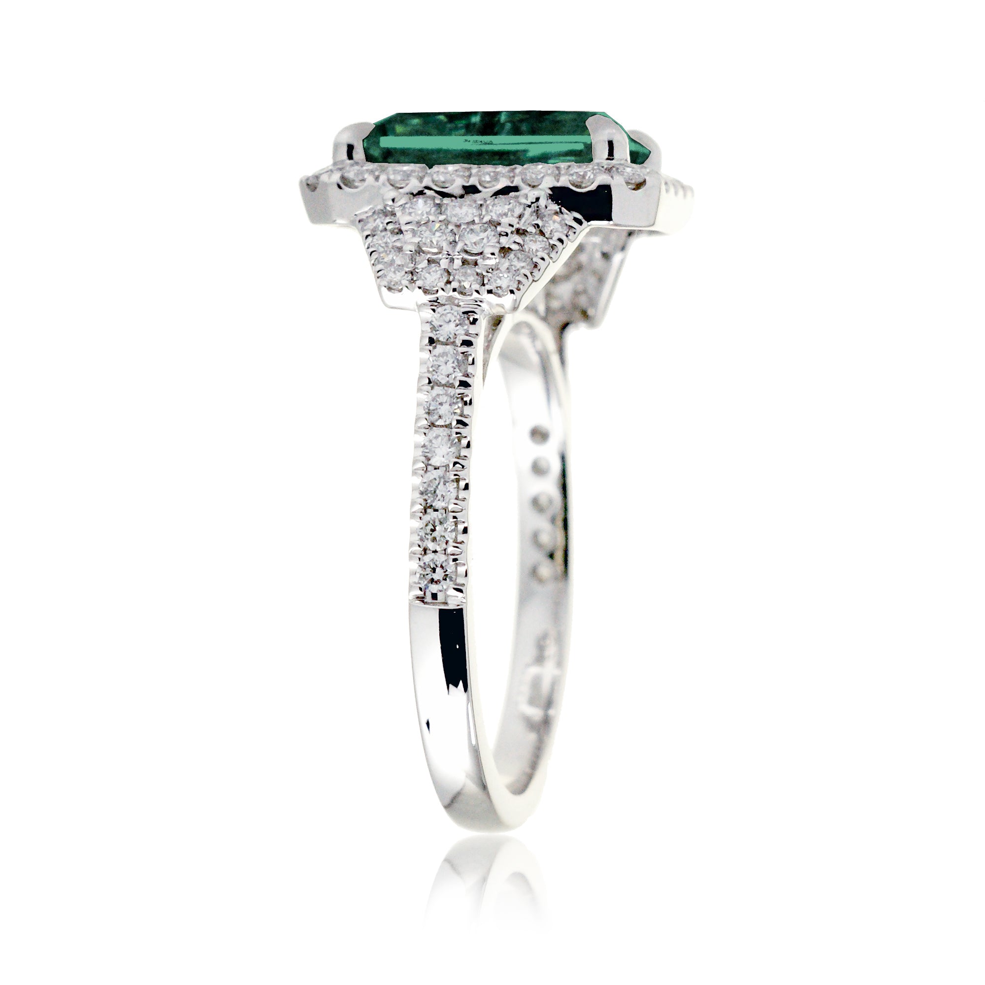 Emerald cut green beryl diamond halo and trapezoid three stone ring white gold