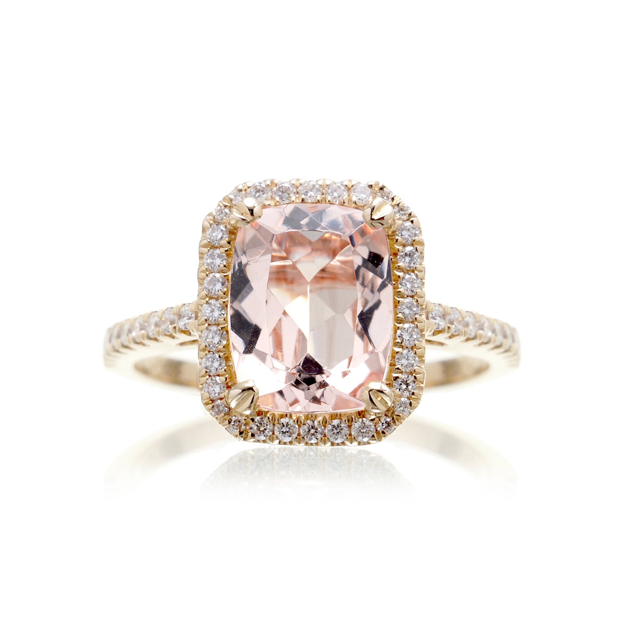 Cushion cut morganite ring with a diamond halo in yellow gold