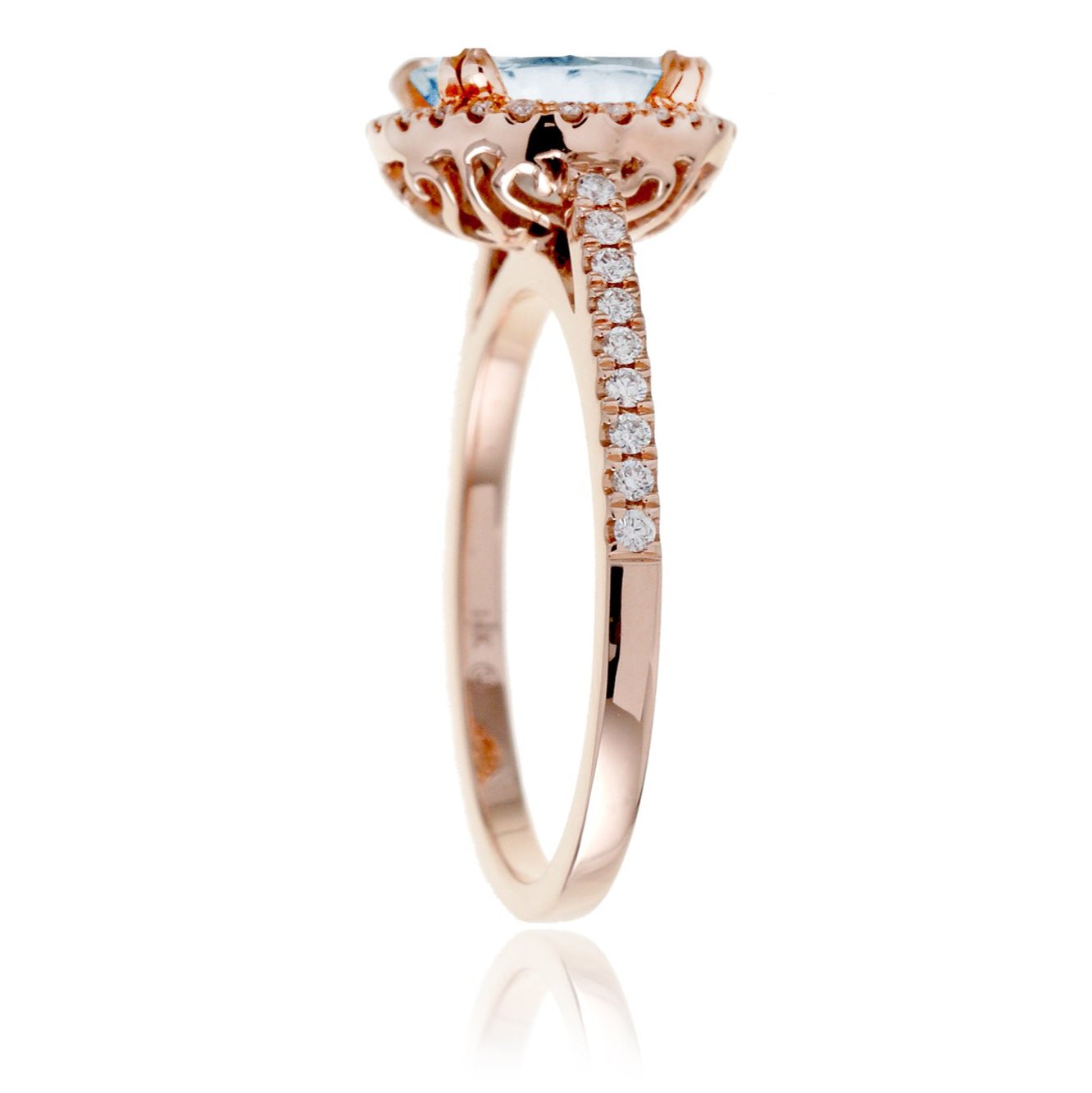 Round aquamarine ring with a diamond halo and cathedral rose gold setting