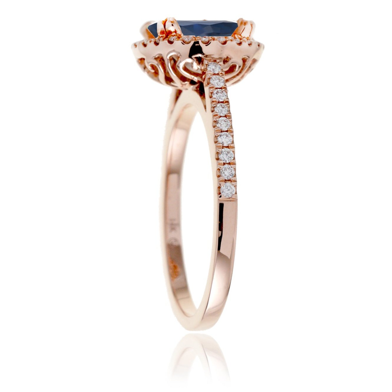 Round sapphire engagement ring with a diamond halo in rose gold