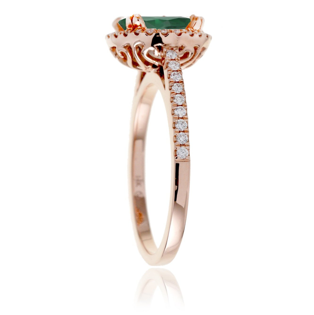 Round cut emerald ring with a diamond halo in rose gold