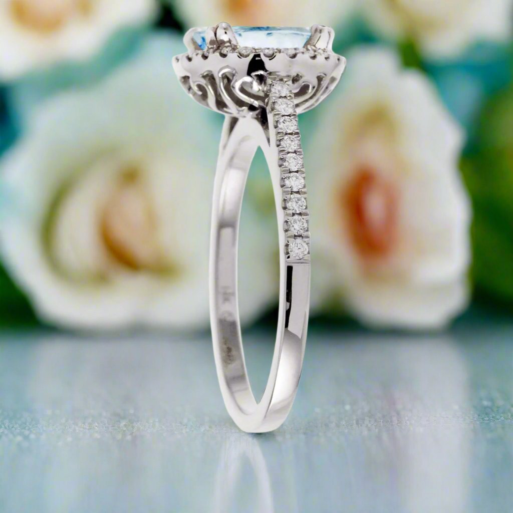 Round aquamarine ring with a diamond halo and cathedral white gold setting